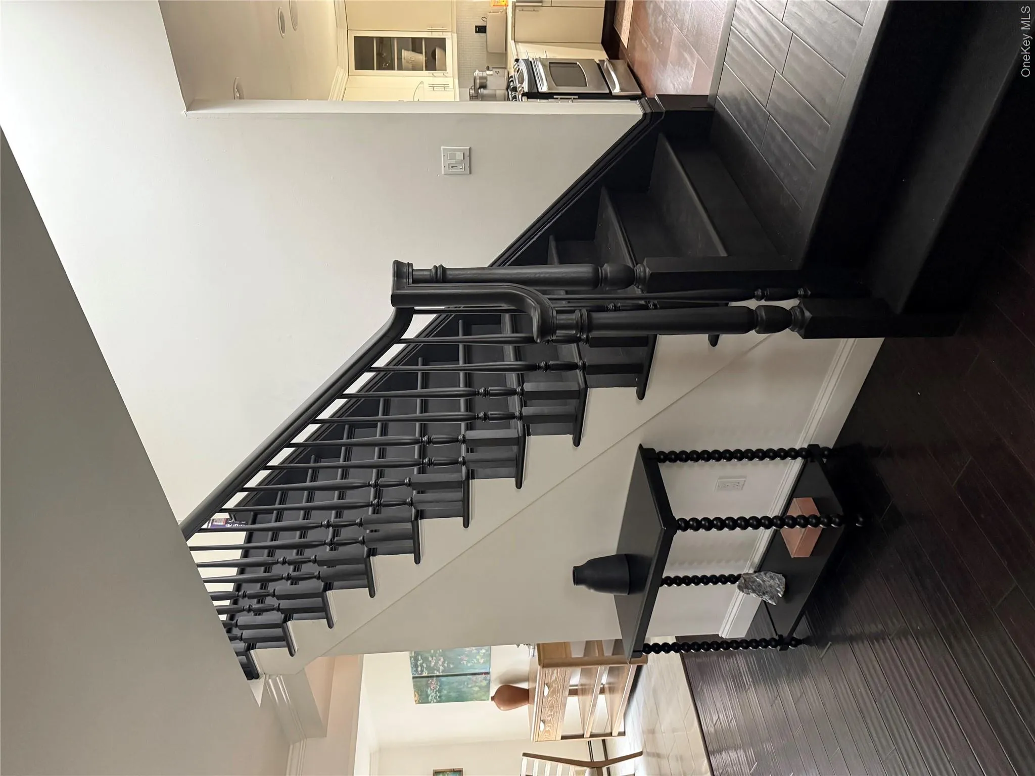 Stairs featuring crown molding, wood finished floors, and baseboards Stairs featuring crown molding, wood finished floors, and baseboards