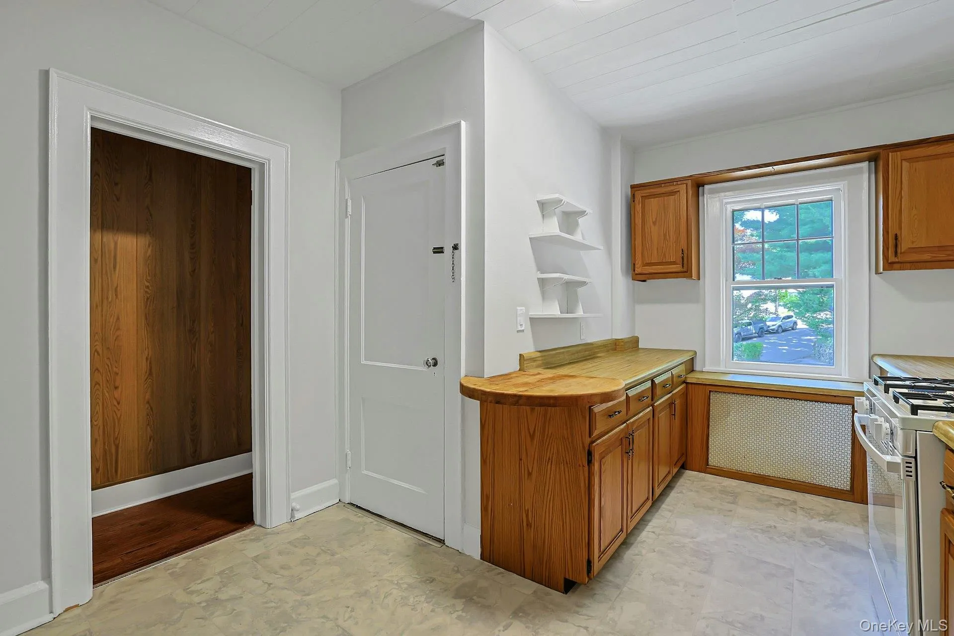 Closed door leads to the full unfinished basement and a second entrance into the home from the driveway. Through the hallway on the left you will find a pantry. The hallway wraps around to the entry hall/front door and stairway to the Bedroom level Closed door leads to the full unfinished basement and a second entrance into the home from the driveway. Through the hallway on the left you will find a pantry. The hallway wraps around to the entry hall/front door and stairway to the Bedroom level