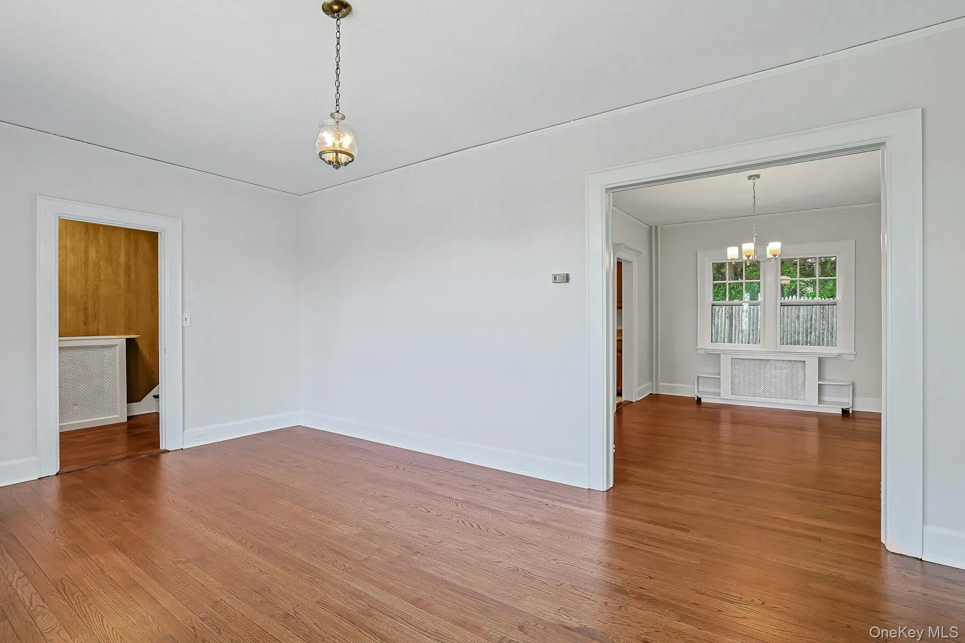 Living Room with entry hall to the left, where you will find a coat closet and stairway to Bedroom level. Dining Room to the right Living Room with entry hall to the left, where you will find a coat closet and stairway to Bedroom level. Dining Room to the right