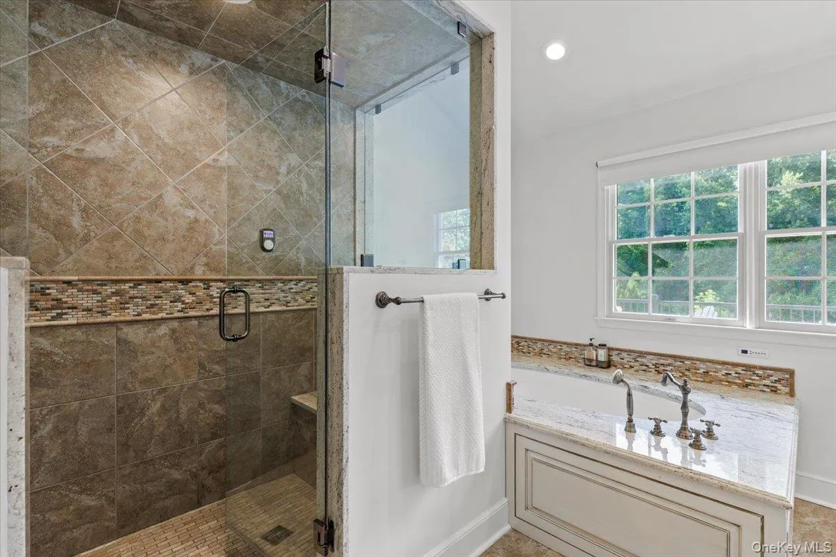 Featuring a steam shower, soaking tub and Toto smart toilet Featuring a steam shower, soaking tub and Toto smart toilet