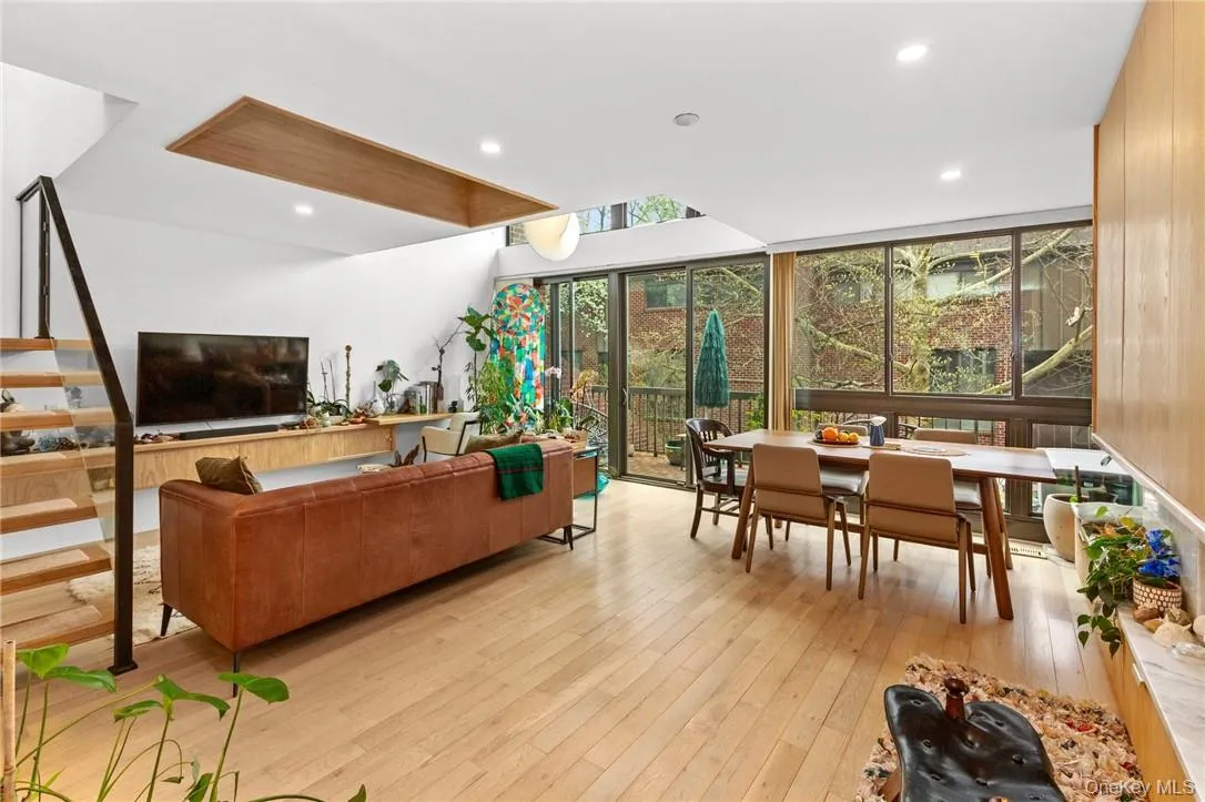 Spacious living and dining area with floor-to-ceiling windows, offering plenty of natural light and a seamless indoor-outdoor flow. Spacious living and dining area with floor-to-ceiling windows, offering plenty of natural light and a seamless indoor-outdoor flow.