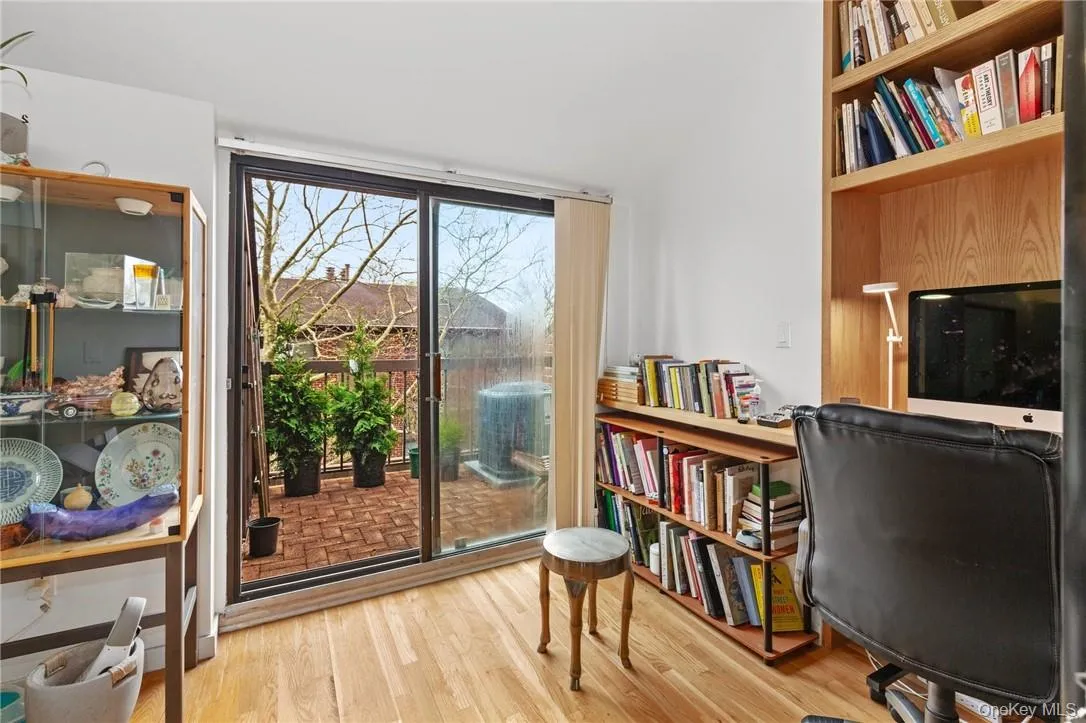 Spacious upstairs office with built-in bookshelves and access to a private balcony, ideal for a productive work-from-home environment. Spacious upstairs office with built-in bookshelves and access to a private balcony, ideal for a productive work-from-home environment.