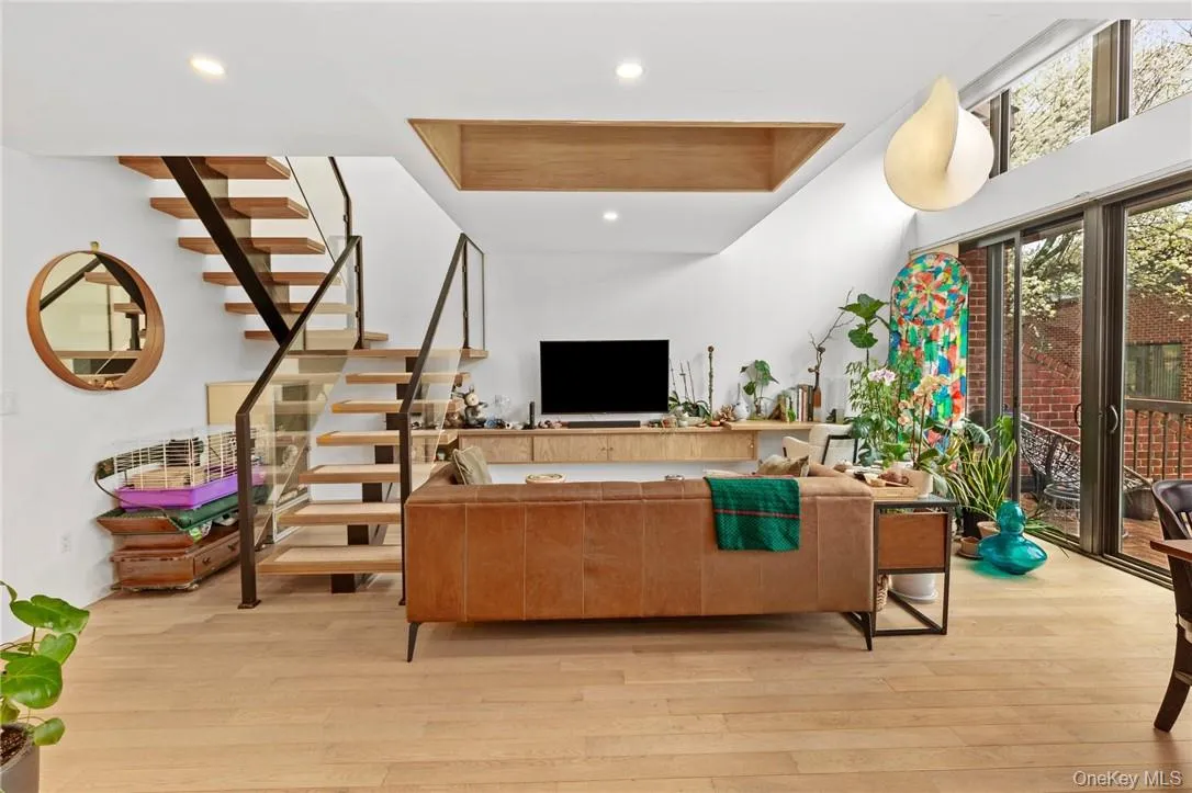 Contemporary living room with high ceilings, custom built-ins, and a beautiful view, providing a perfect blend of comfort and style. Contemporary living room with high ceilings, custom built-ins, and a beautiful view, providing a perfect blend of comfort and style.