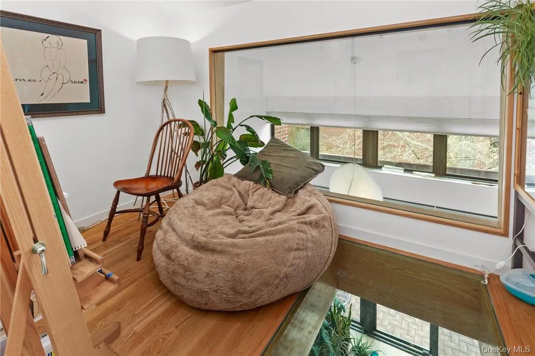 Cozy reading nook with large window, perfect for relaxation and enjoying the view. Cozy reading nook with large window, perfect for relaxation and enjoying the view.