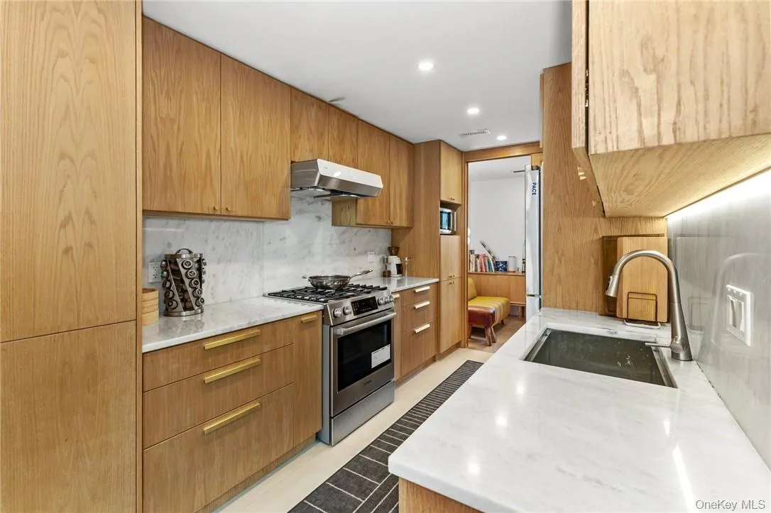 Stylish kitchen featuring marble countertops, custom cabinetry, and contemporary fixtures for a sophisticated cooking experience. Stylish kitchen featuring marble countertops, custom cabinetry, and contemporary fixtures for a sophisticated cooking experience.