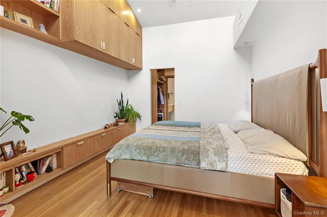 Serene primary suite featuring high ceilings, custom built-in storage, and a walk-in closet for ultimate comfort and organization. Serene primary suite featuring high ceilings, custom built-in storage, and a walk-in closet for ultimate comfort and organization.