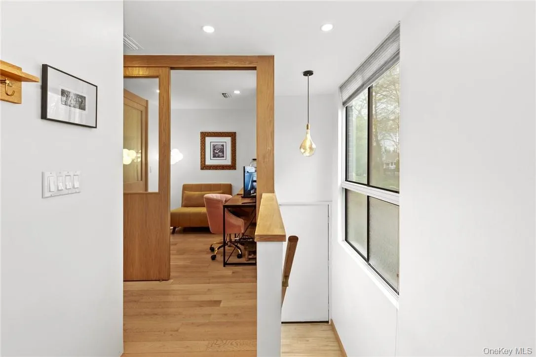 Bright and inviting entryway leads to a versatile office/reading nook, perfect for work-from-home privacy or relaxation. Bright and inviting entryway leads to a versatile office/reading nook, perfect for work-from-home privacy or relaxation.