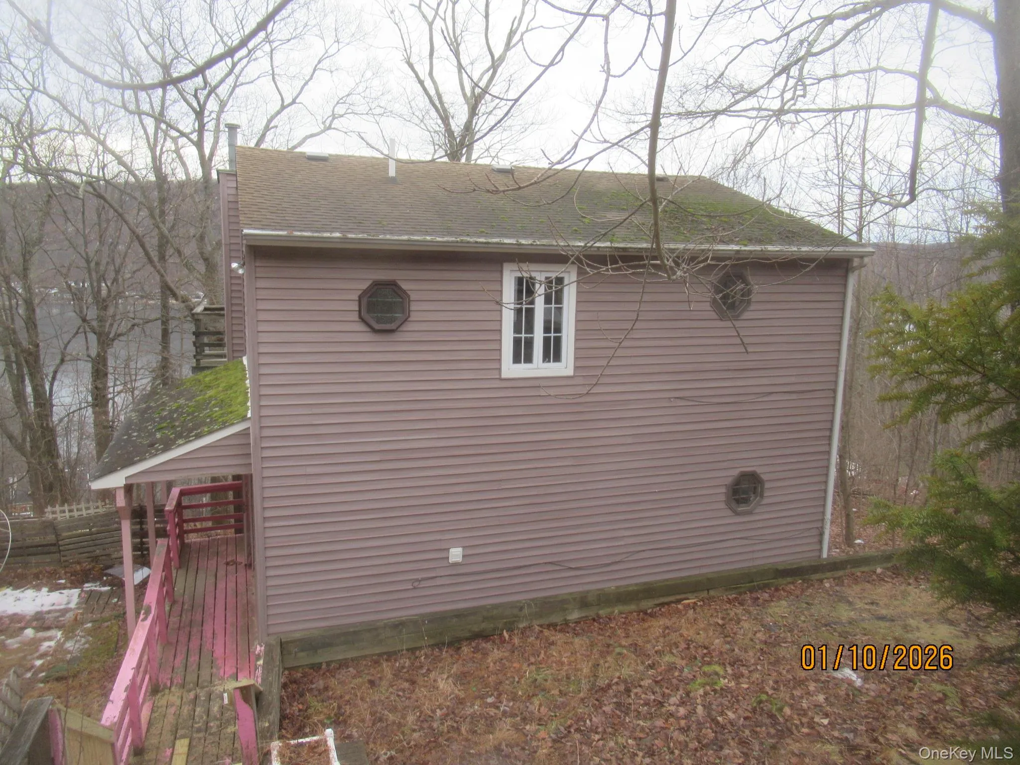 View of side of property featuring a shingled roof View of side of property featuring a shingled roof