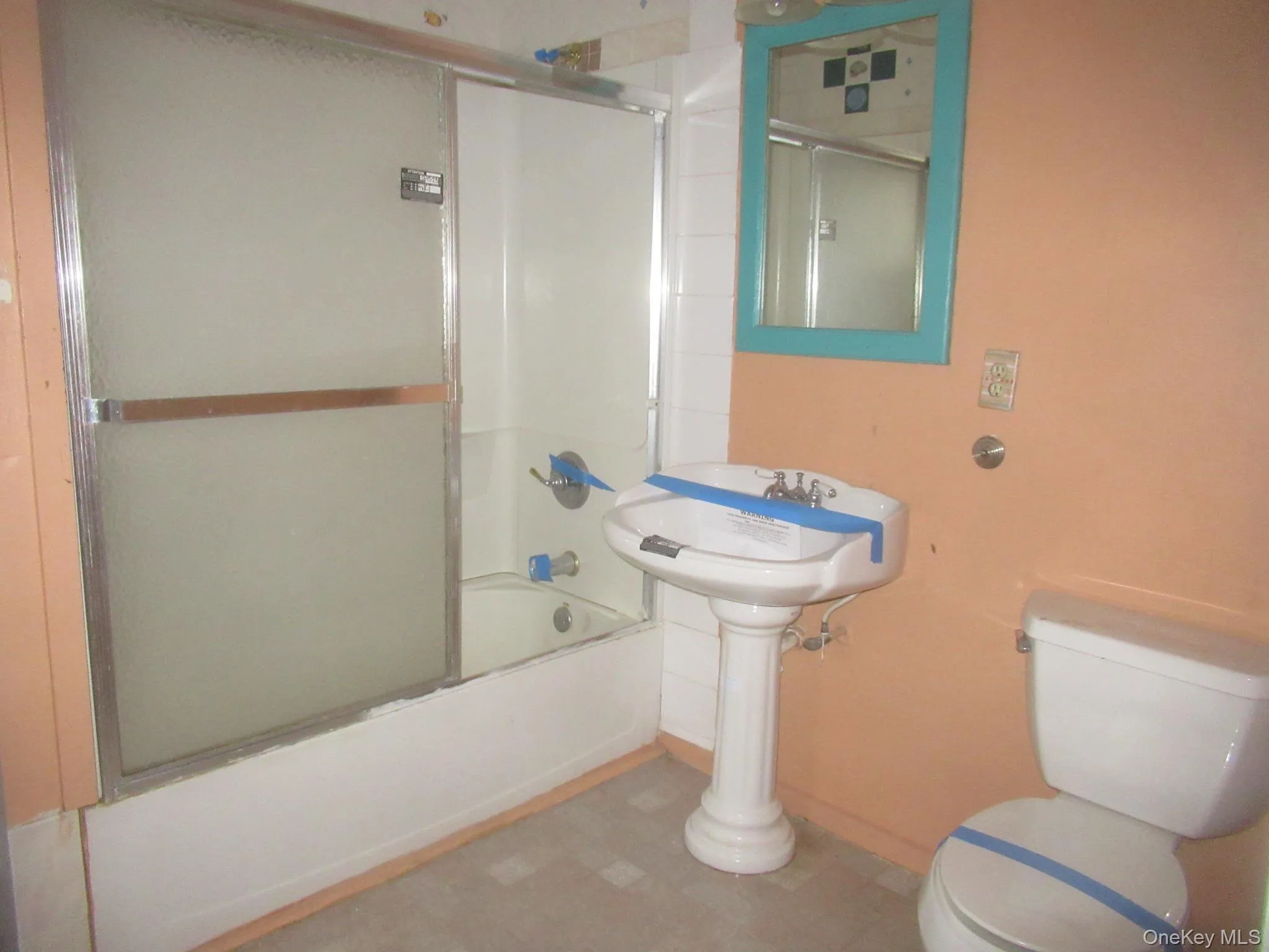 Full bath with bath / shower combo with glass door and tile patterned floors Full bath with bath / shower combo with glass door and tile patterned floors