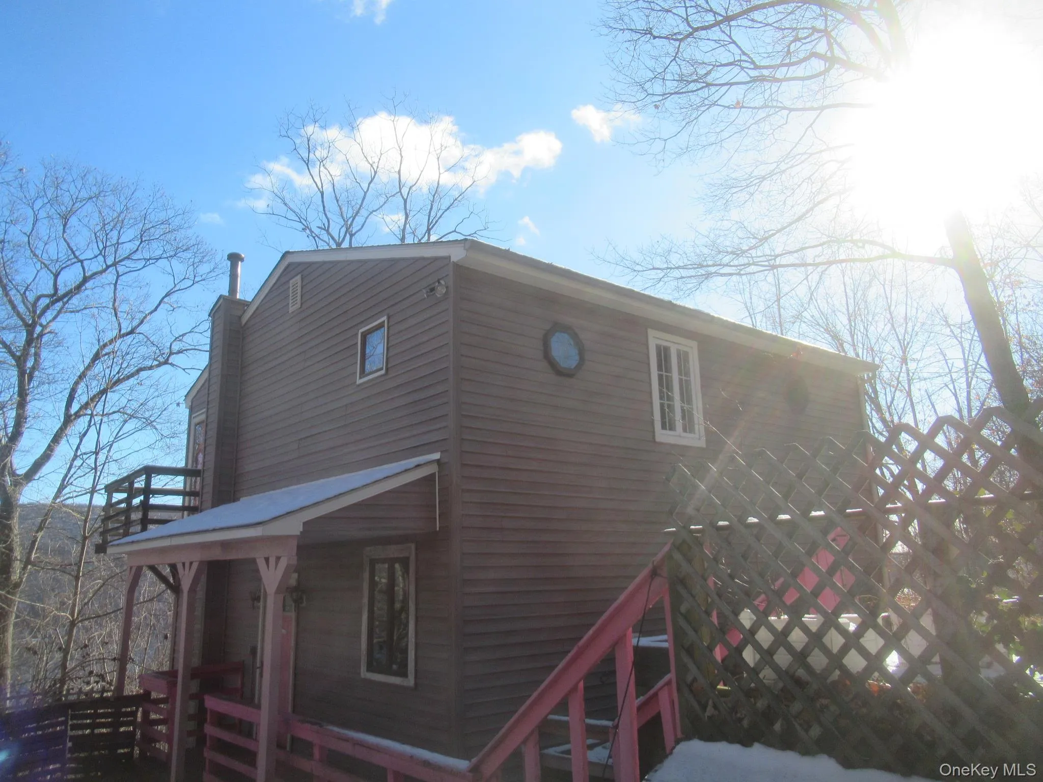 View of side of home featuring a chimney View of side of home featuring a chimney