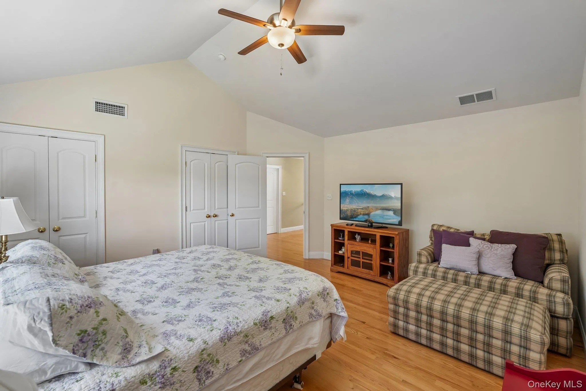 Bedroom with hardwood floors and ceiling fam. Bedroom with hardwood floors and ceiling fam.