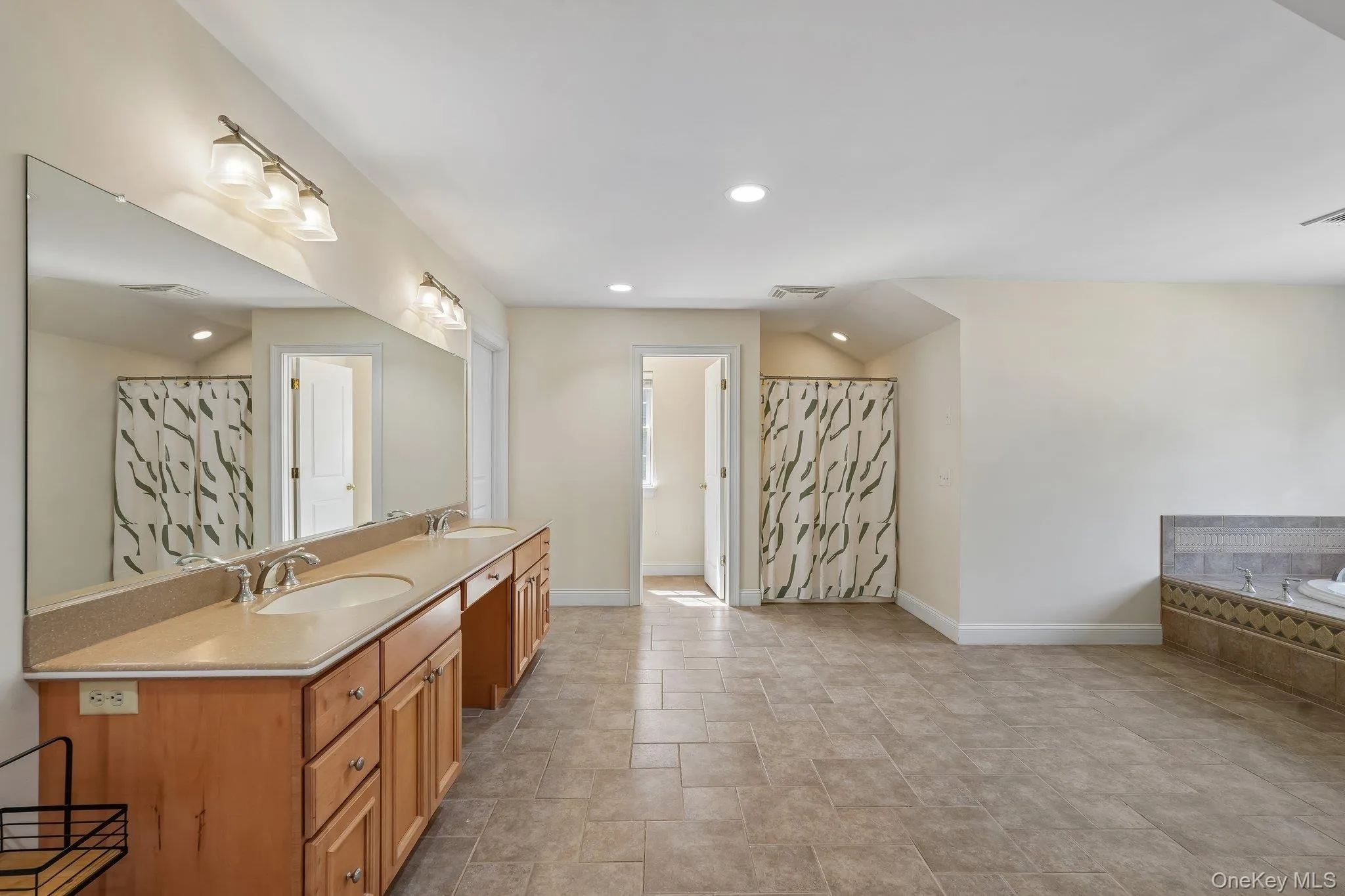 Primary bathroom with dual sinks, whirlpool tub and separate shower. Primary bathroom with dual sinks, whirlpool tub and separate shower.