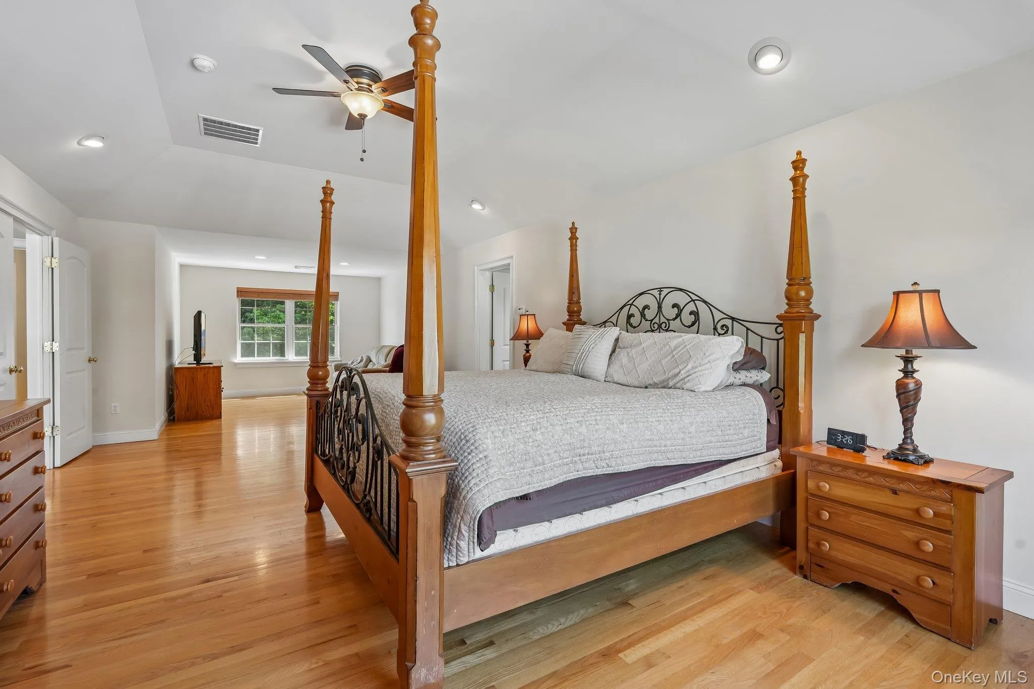 Huge primary bedroom with hardwood floors and tray ceiling. Huge primary bedroom with hardwood floors and tray ceiling.