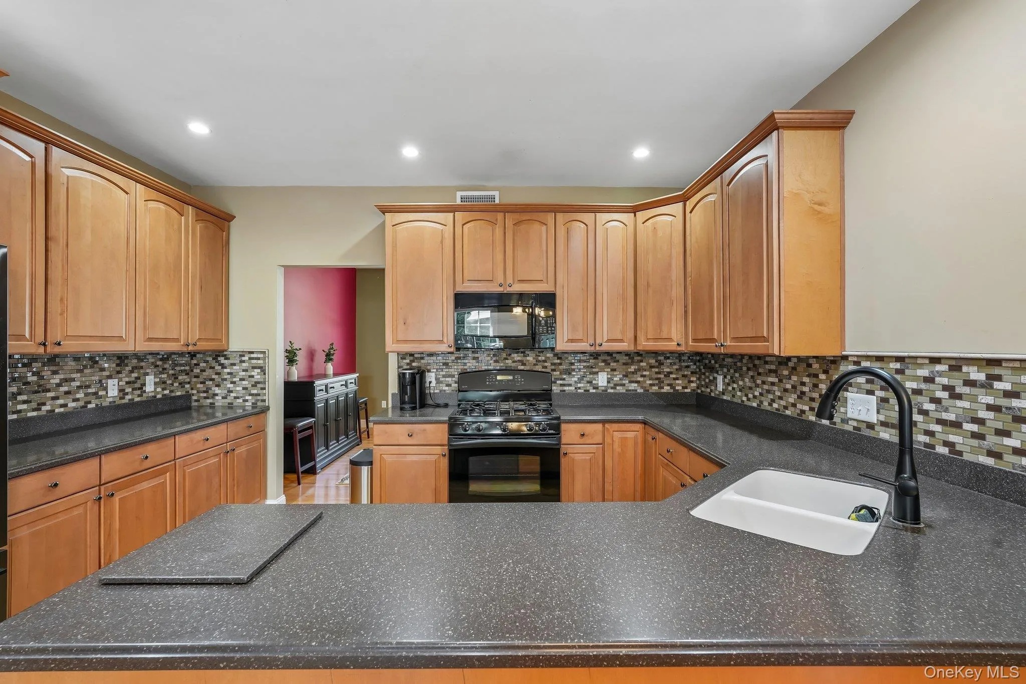 Efficient style kitchen with corian ocunter tops and maple cabinets. Efficient style kitchen with corian ocunter tops and maple cabinets.