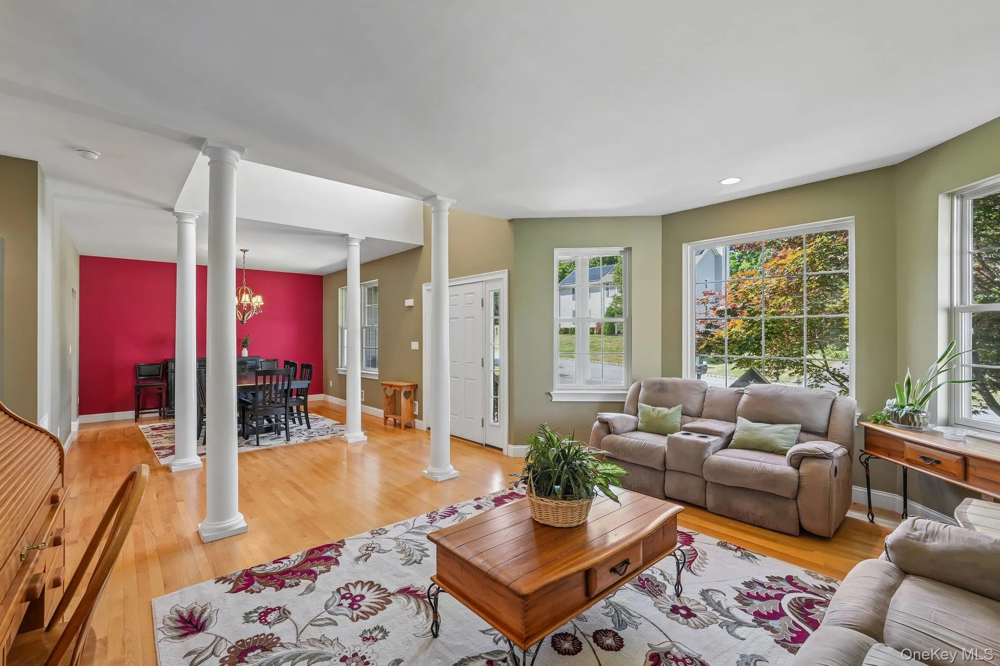 Formal living room with plenty of natural light, hardwood floors and decorative columns. Formal living room with plenty of natural light, hardwood floors and decorative columns.