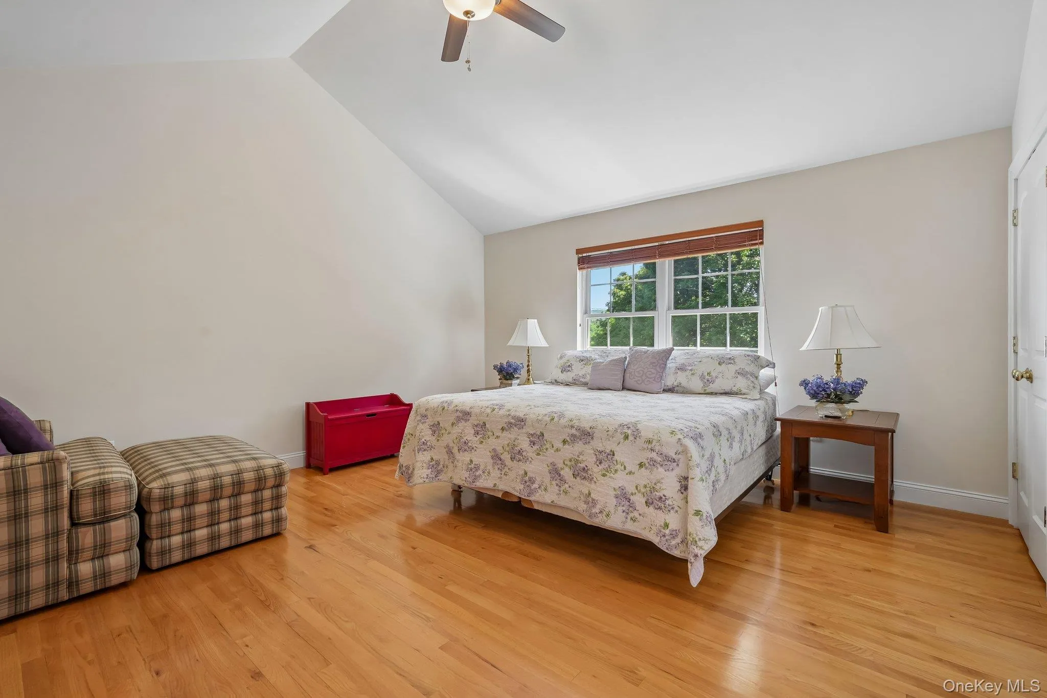 Bedroom with hardwood floors and ceiling fam. Bedroom with hardwood floors and ceiling fam.