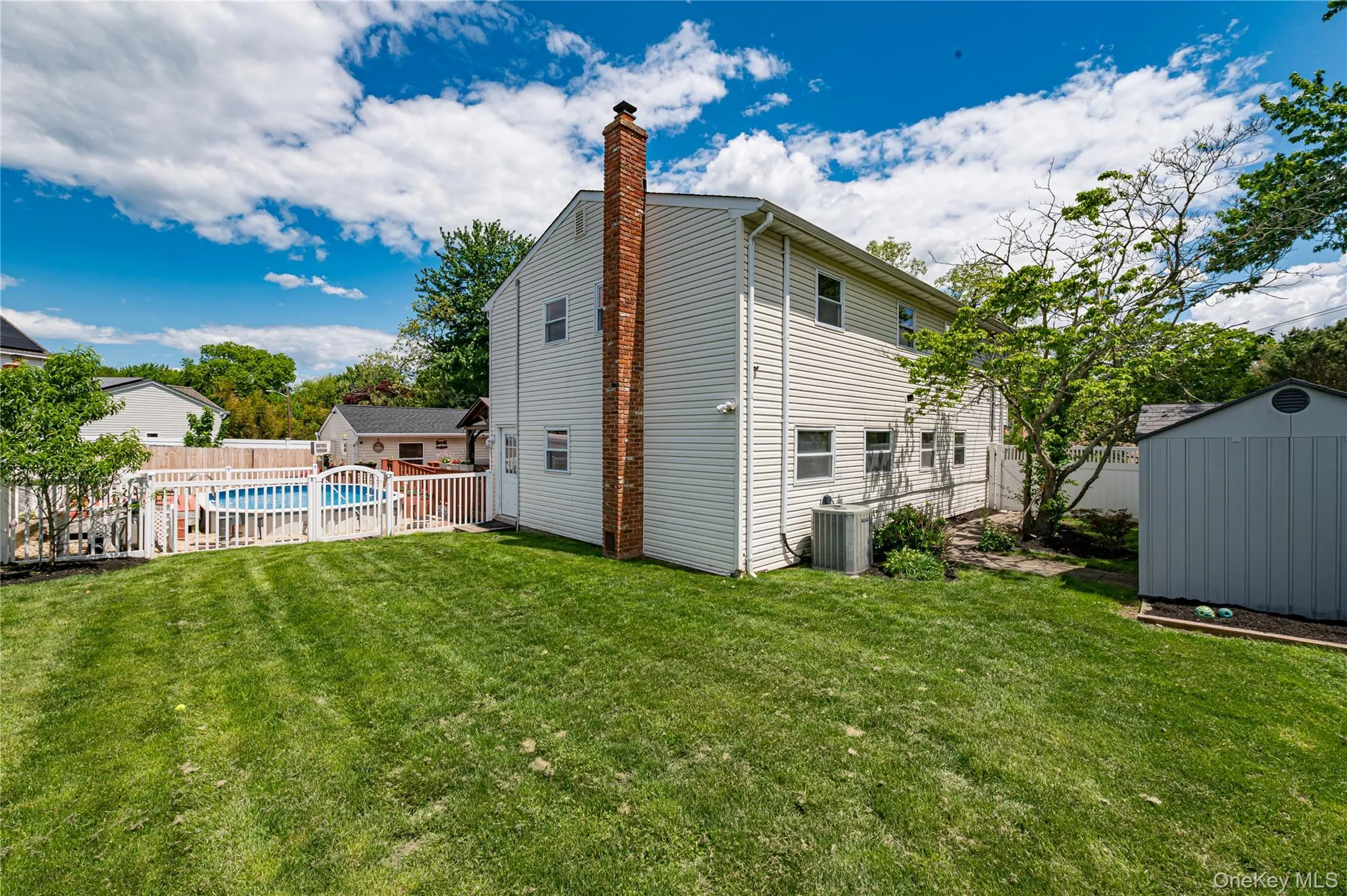 Expansive backyard featuring a manicured lawn Expansive backyard featuring a manicured lawn