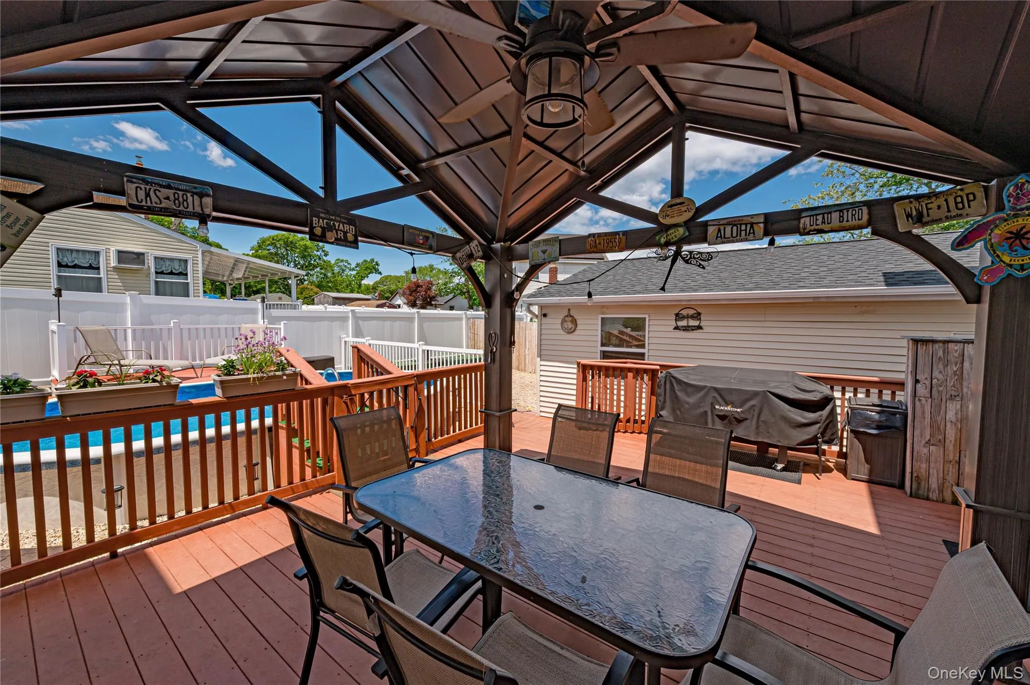 Expansive outdoor deck featuring a covered gazebo with an integrated ceiling fan Expansive outdoor deck featuring a covered gazebo with an integrated ceiling fan