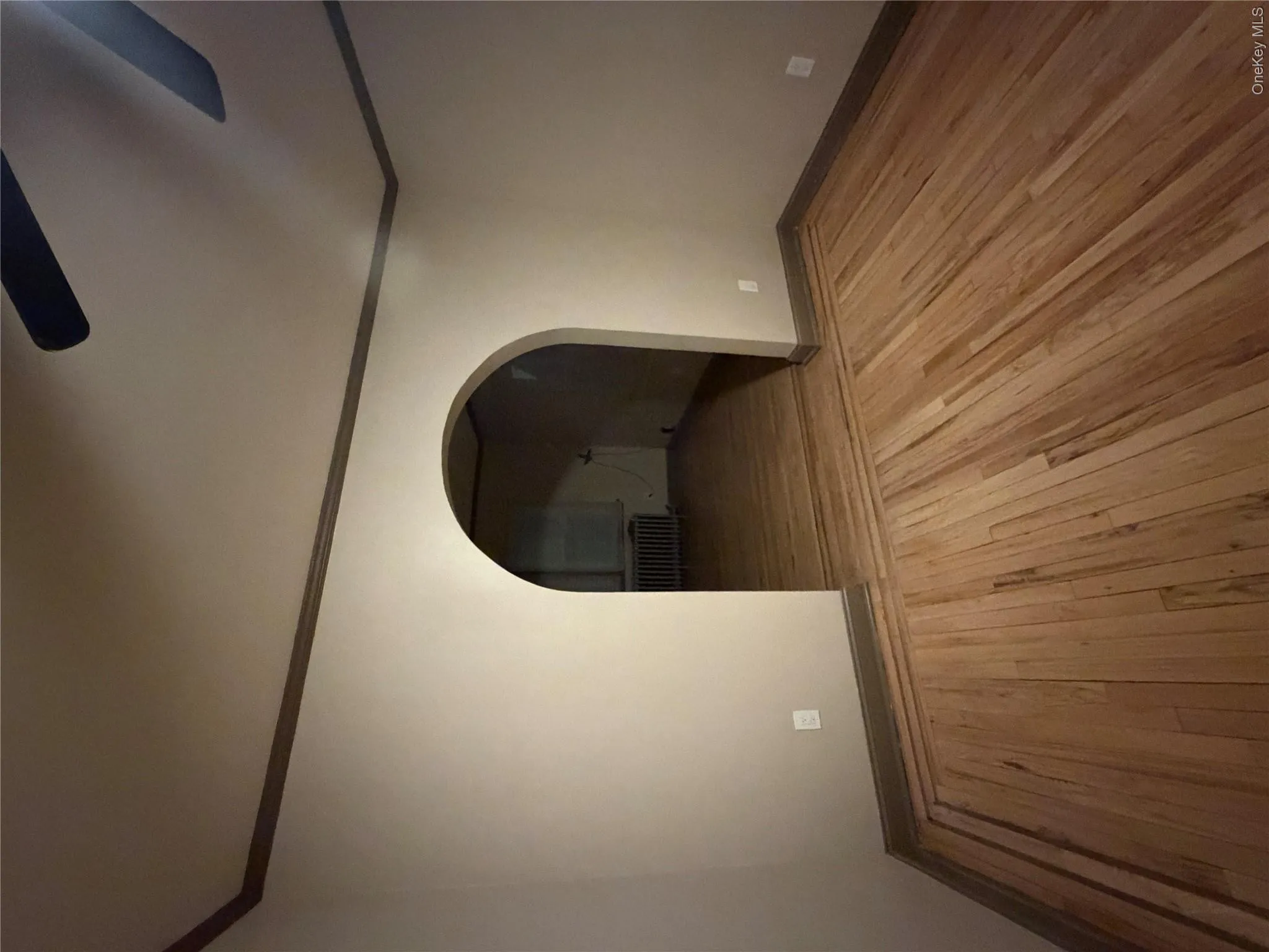 Hardwood flooring with perimeter inlay, arched entryway, and baseboard molding Hardwood flooring with perimeter inlay, arched entryway, and baseboard molding