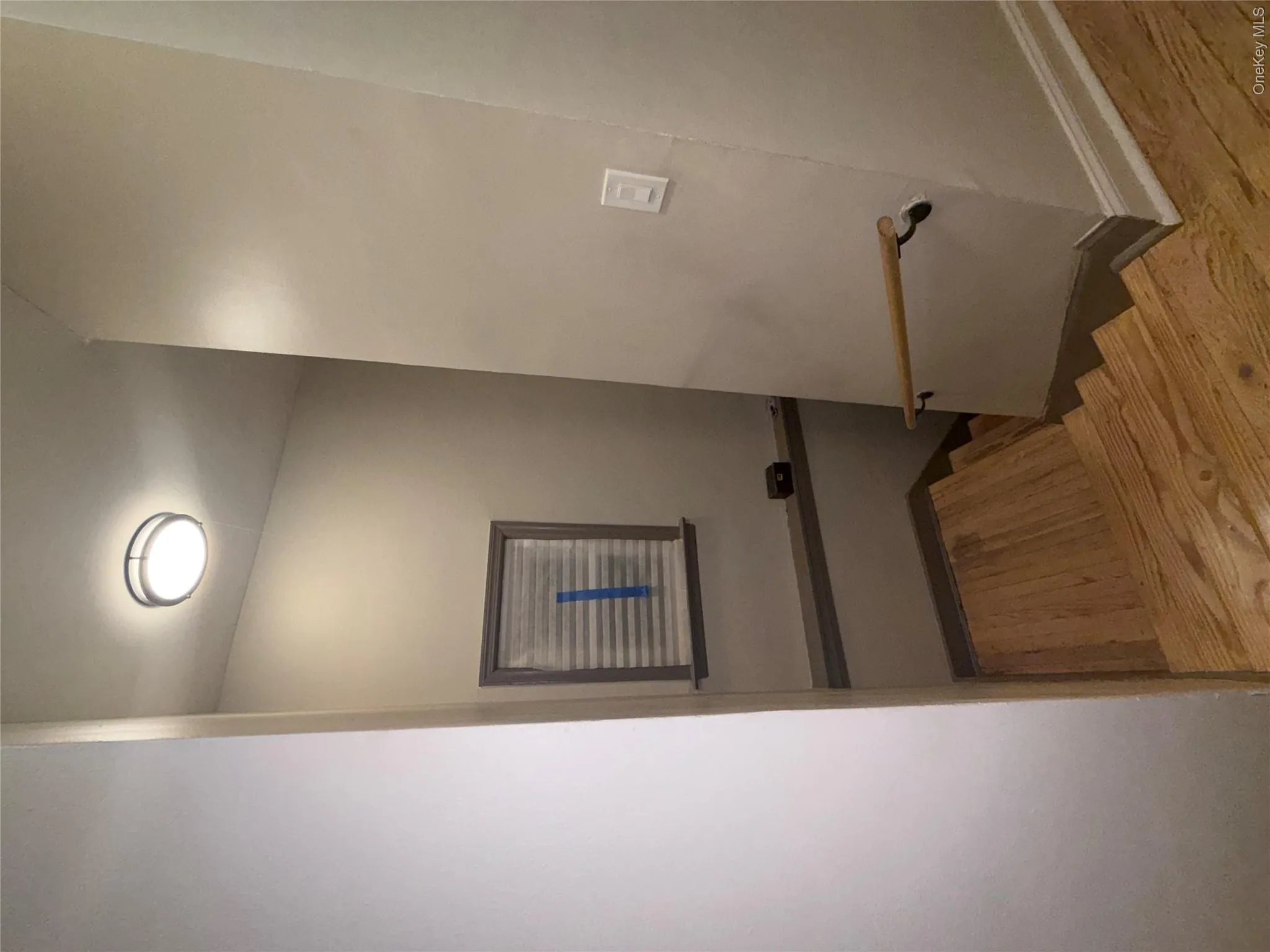 Hardwood stairs with a natural wood handrail and dark metal brackets Hardwood stairs with a natural wood handrail and dark metal brackets