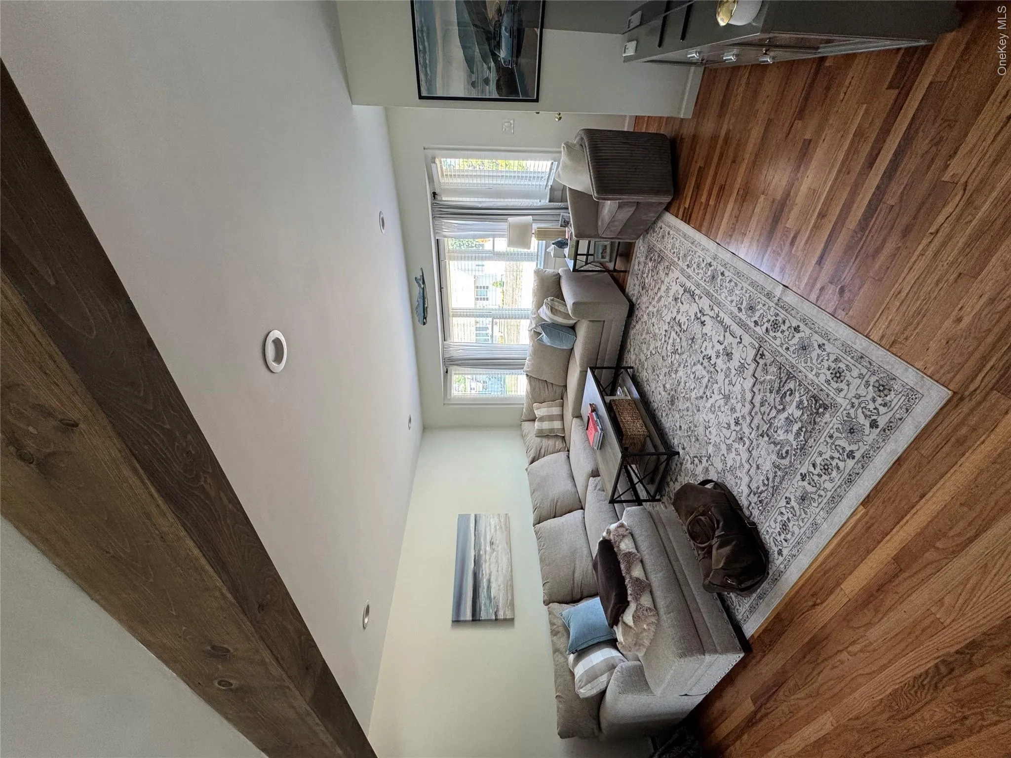 Living area featuring exposed wood ceiling beams and recessed lighting Living area featuring exposed wood ceiling beams and recessed lighting