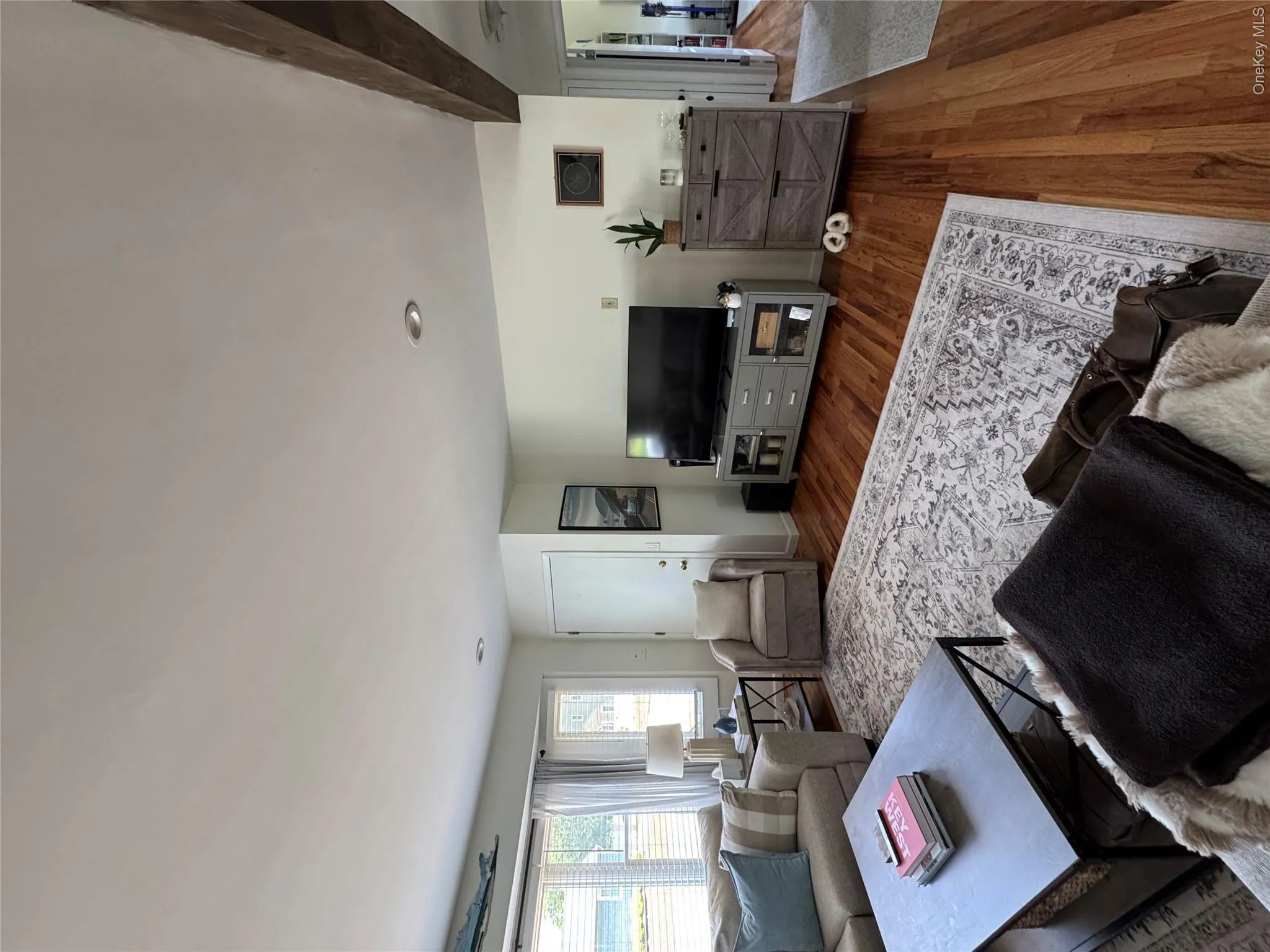 Hardwood flooring throughout a spacious living area featuring recessed lighting Hardwood flooring throughout a spacious living area featuring recessed lighting