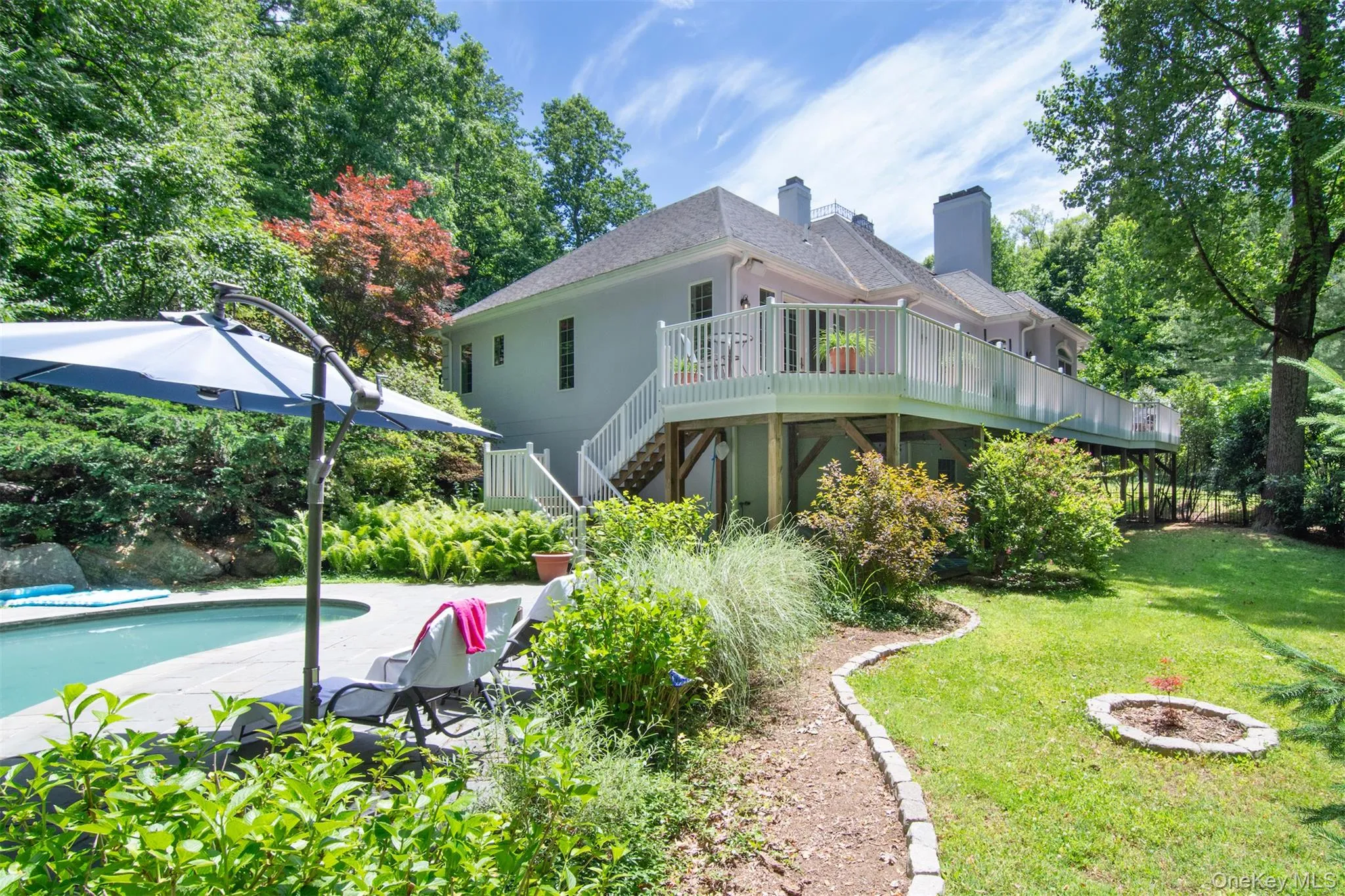 View from the pool area, 2 levels of living, walk out lower level, all the rooms on the back of the house, including the primary bedroom have access to the deck View from the pool area, 2 levels of living, walk out lower level, all the rooms on the back of the house, including the primary bedroom have access to the deck