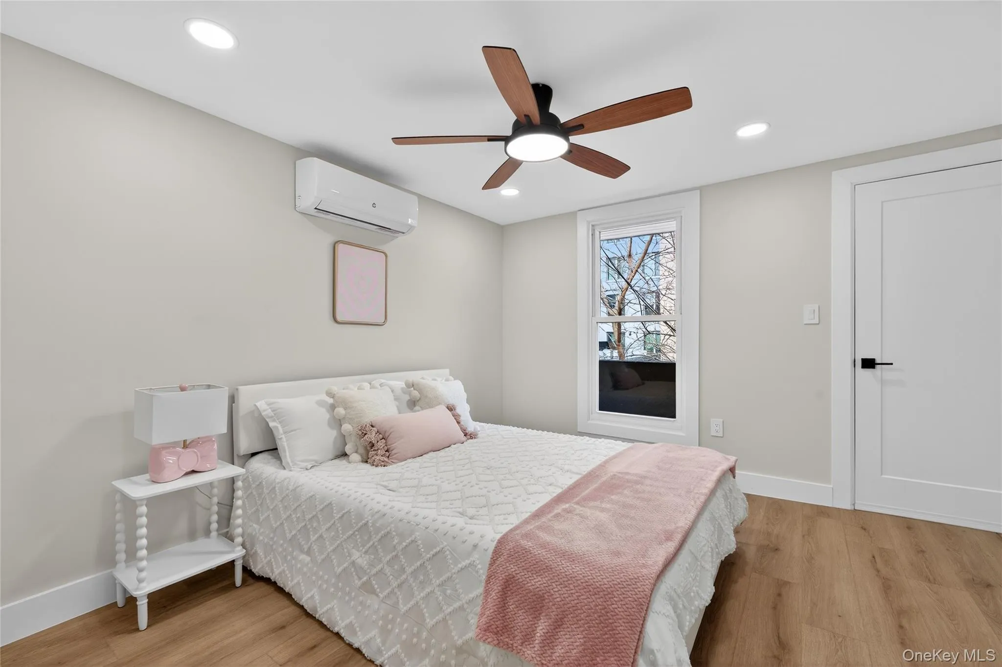 Bedroom featuring wood-finish flooring, recessed lighting, and a ceiling fan with integrated lighting Bedroom featuring wood-finish flooring, recessed lighting, and a ceiling fan with integrated lighting