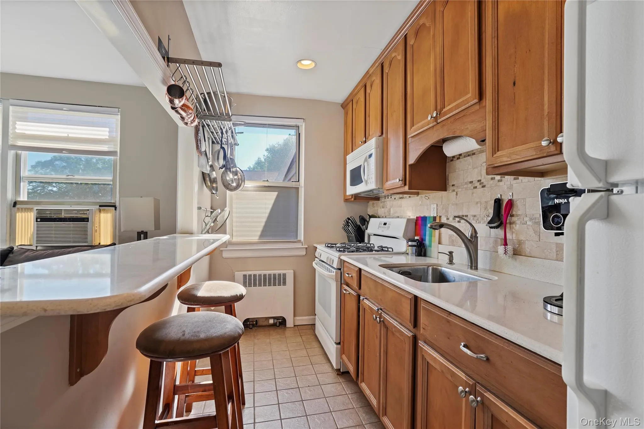 Modern Open Kitchen With Full Heights Cabinetry, Gas Range, Bar Seating & Natural Light Modern Open Kitchen With Full Heights Cabinetry, Gas Range, Bar Seating & Natural Light