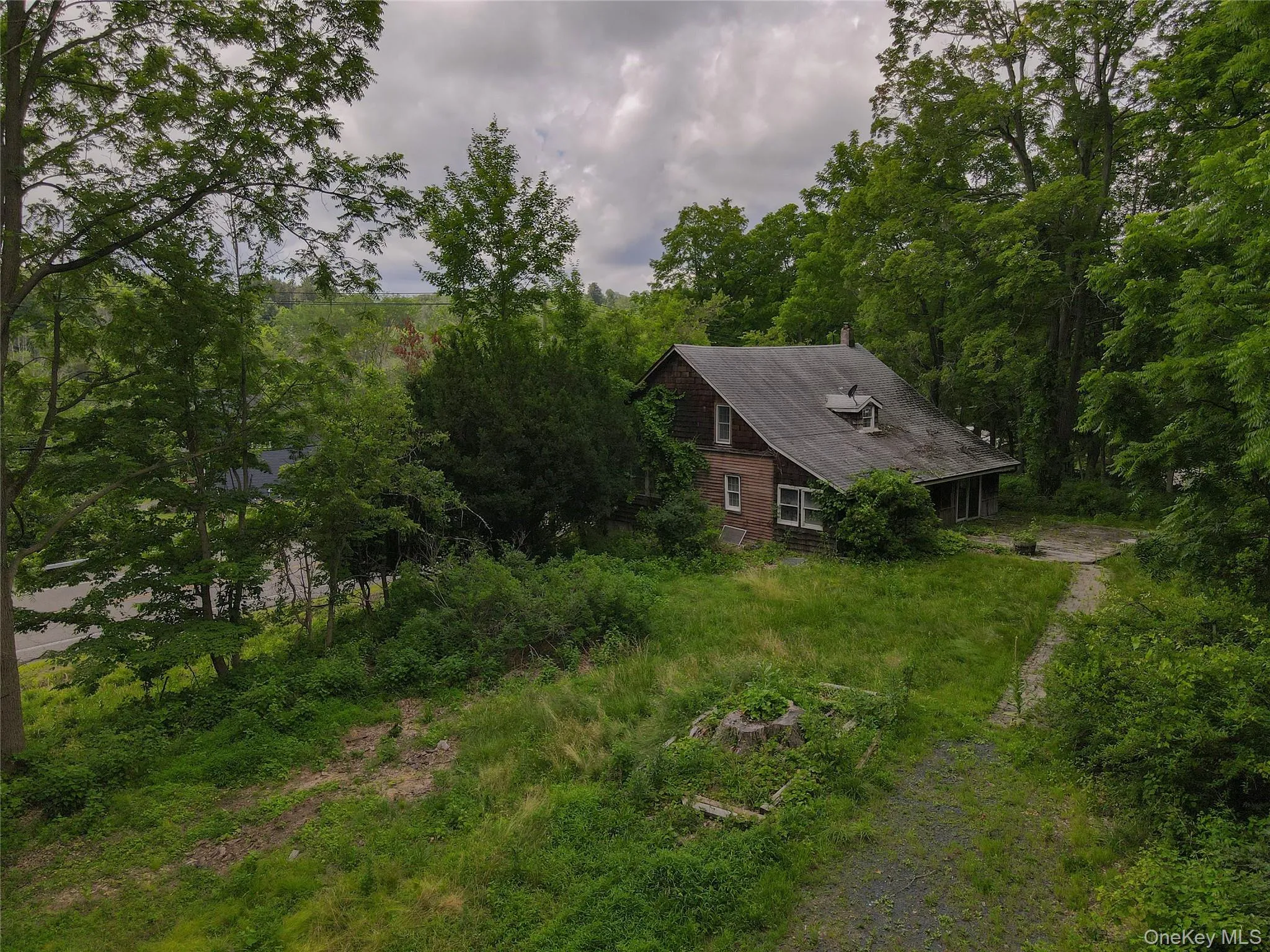 View of subject property with a forest View of subject property with a forest
