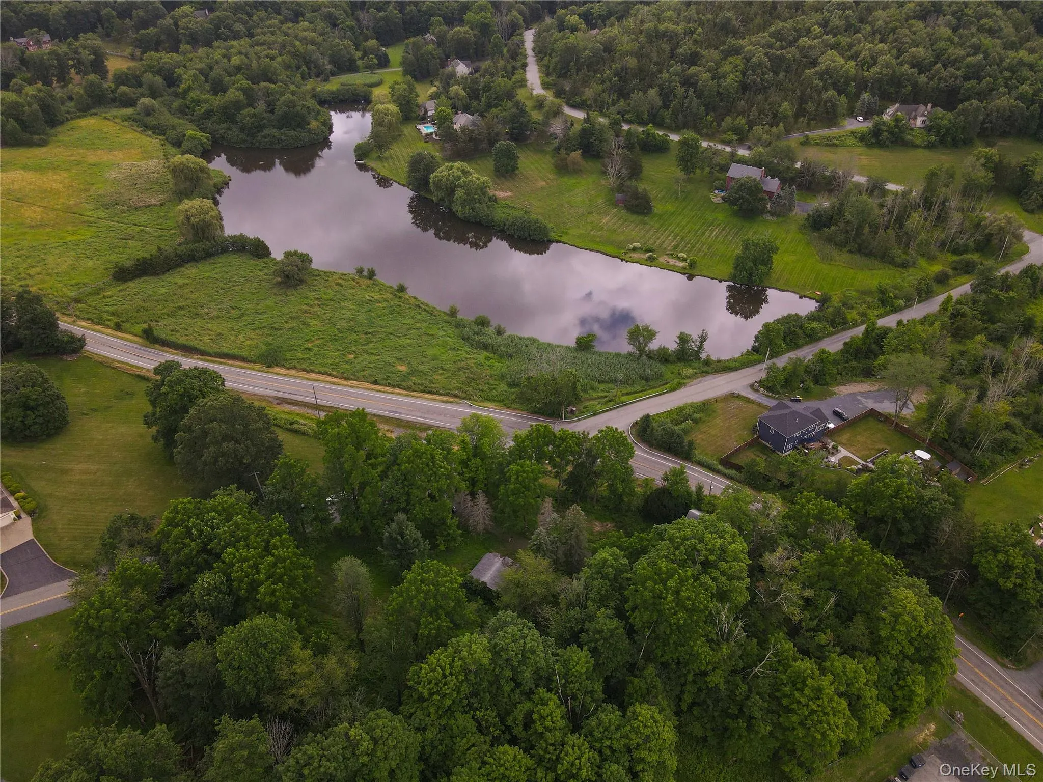 Aerial view of property and surrounding area featuring a large body of water Aerial view of property and surrounding area featuring a large body of water