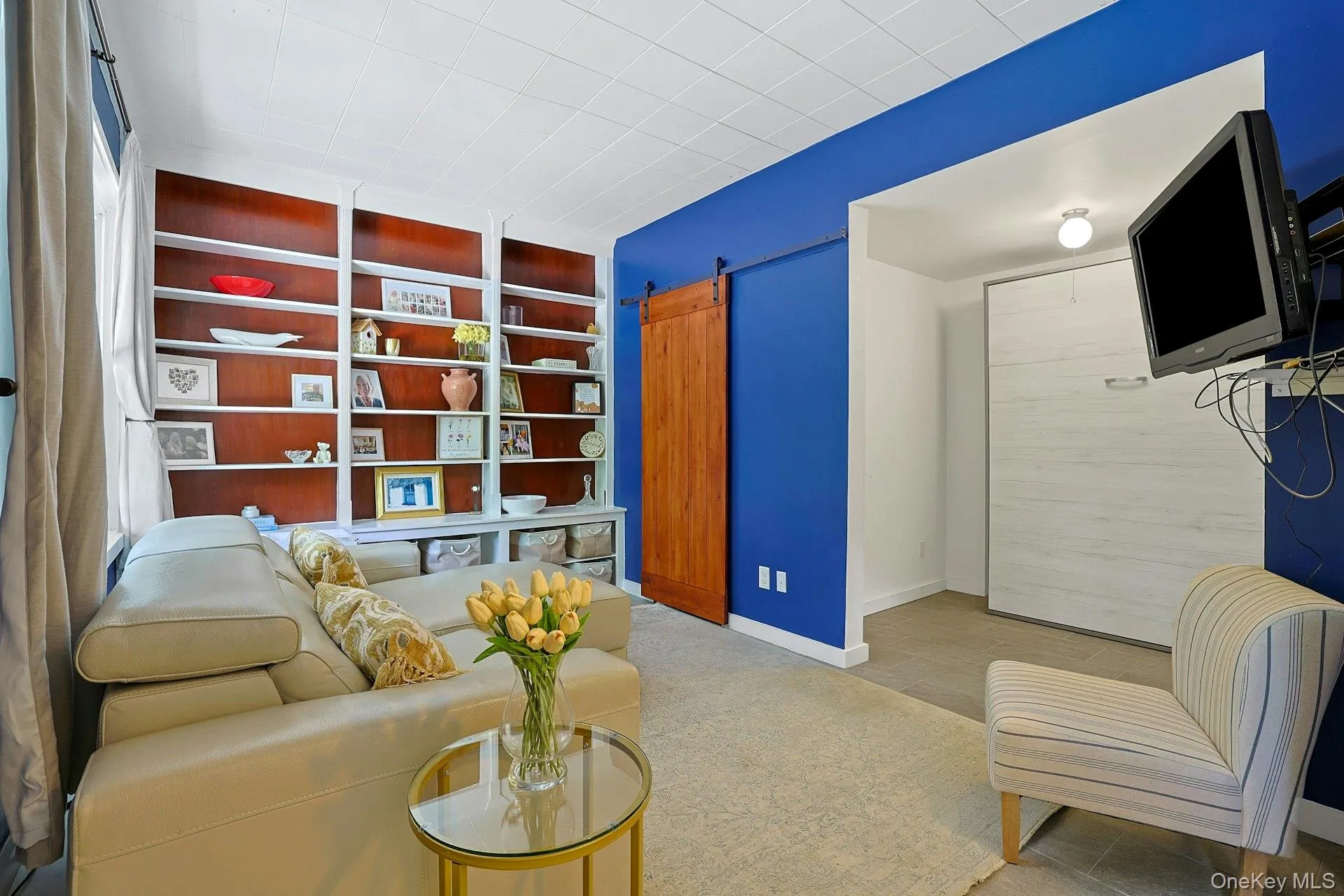 The Murphy bed is located on the right side of photo within the library. The Murphy bed is located on the right side of photo within the library.
