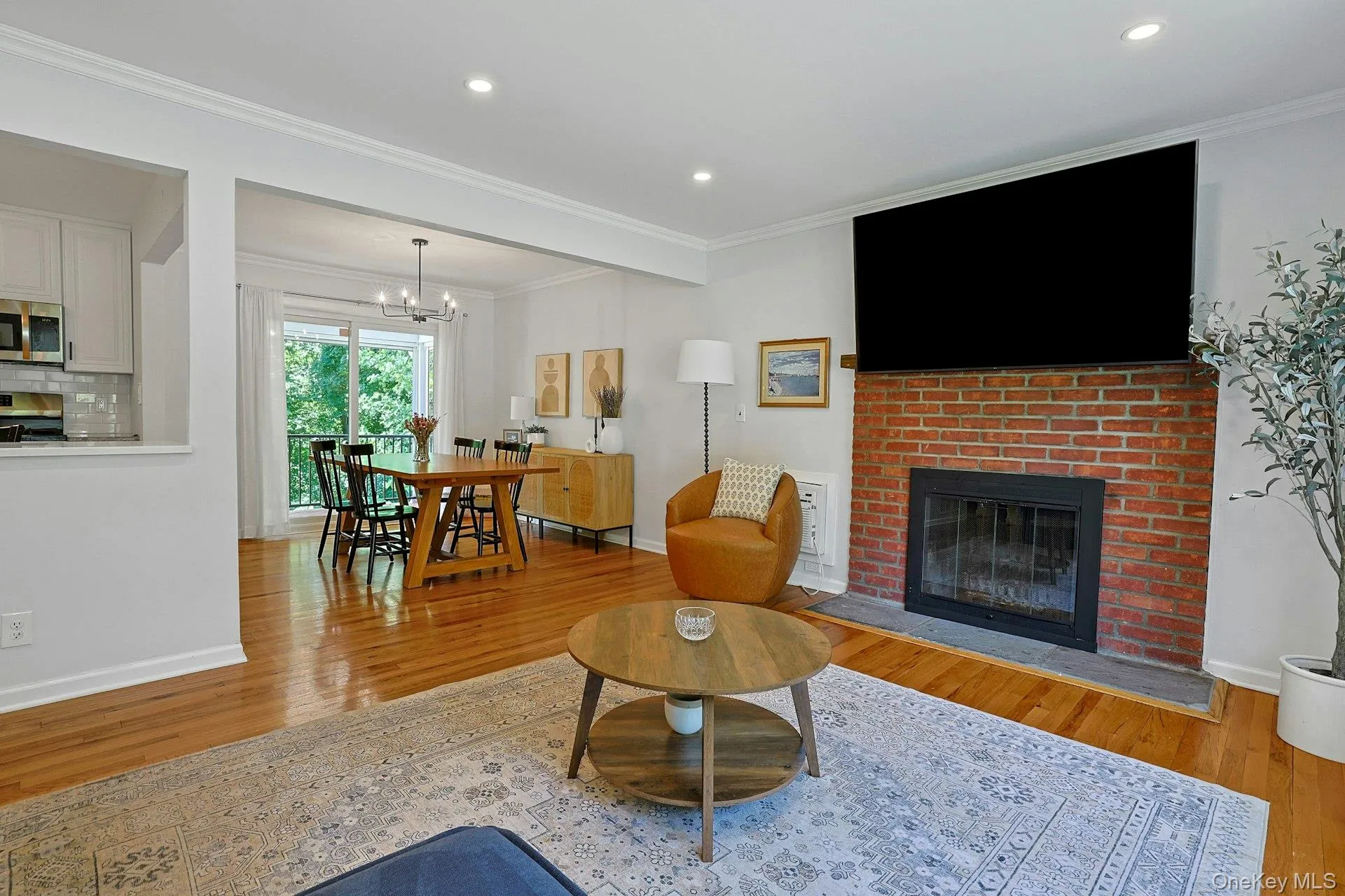 There are hardwood floors throughout the living room and dining area. There are hardwood floors throughout the living room and dining area.