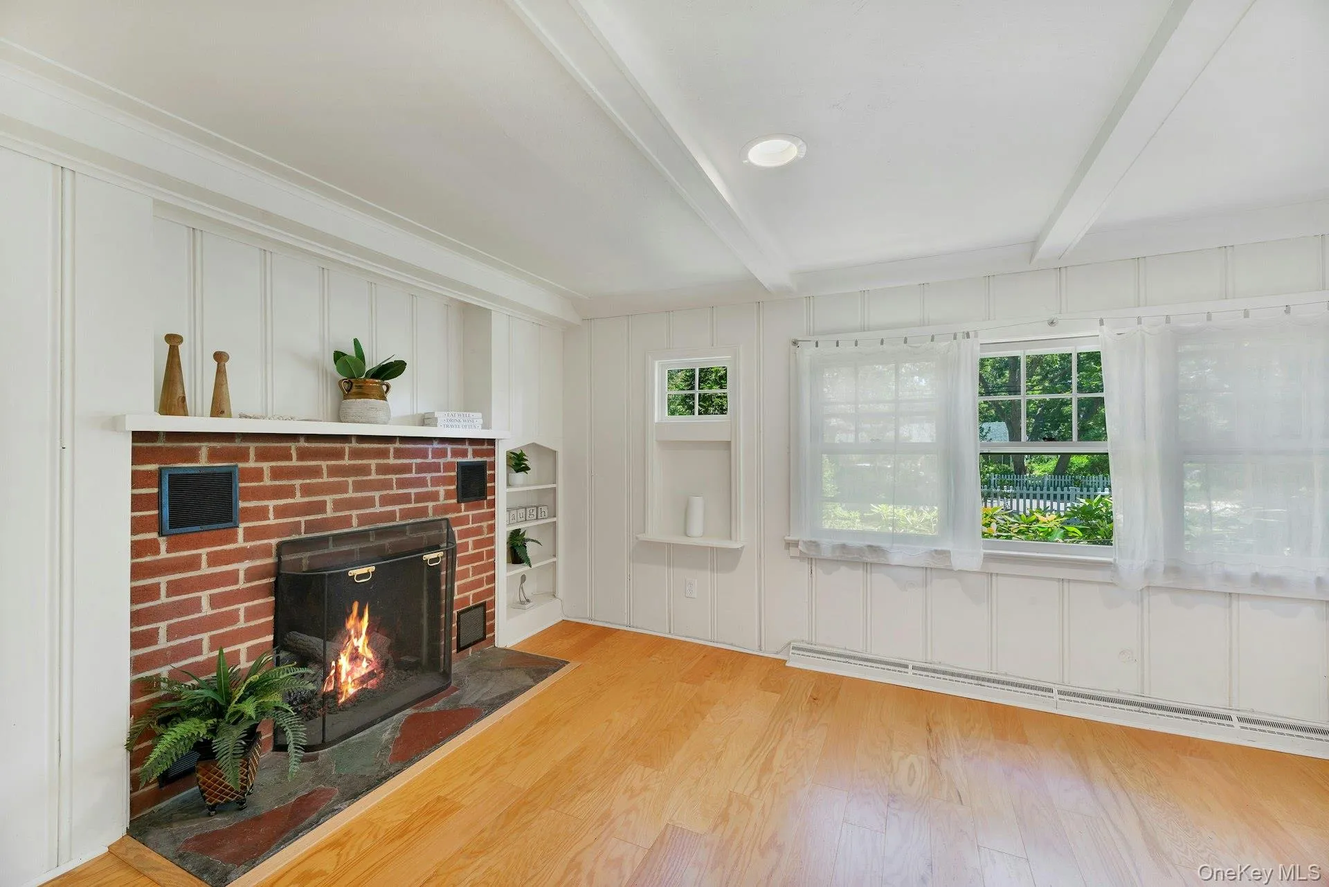 Spacious living room with charming fireplace. Spacious living room with charming fireplace.