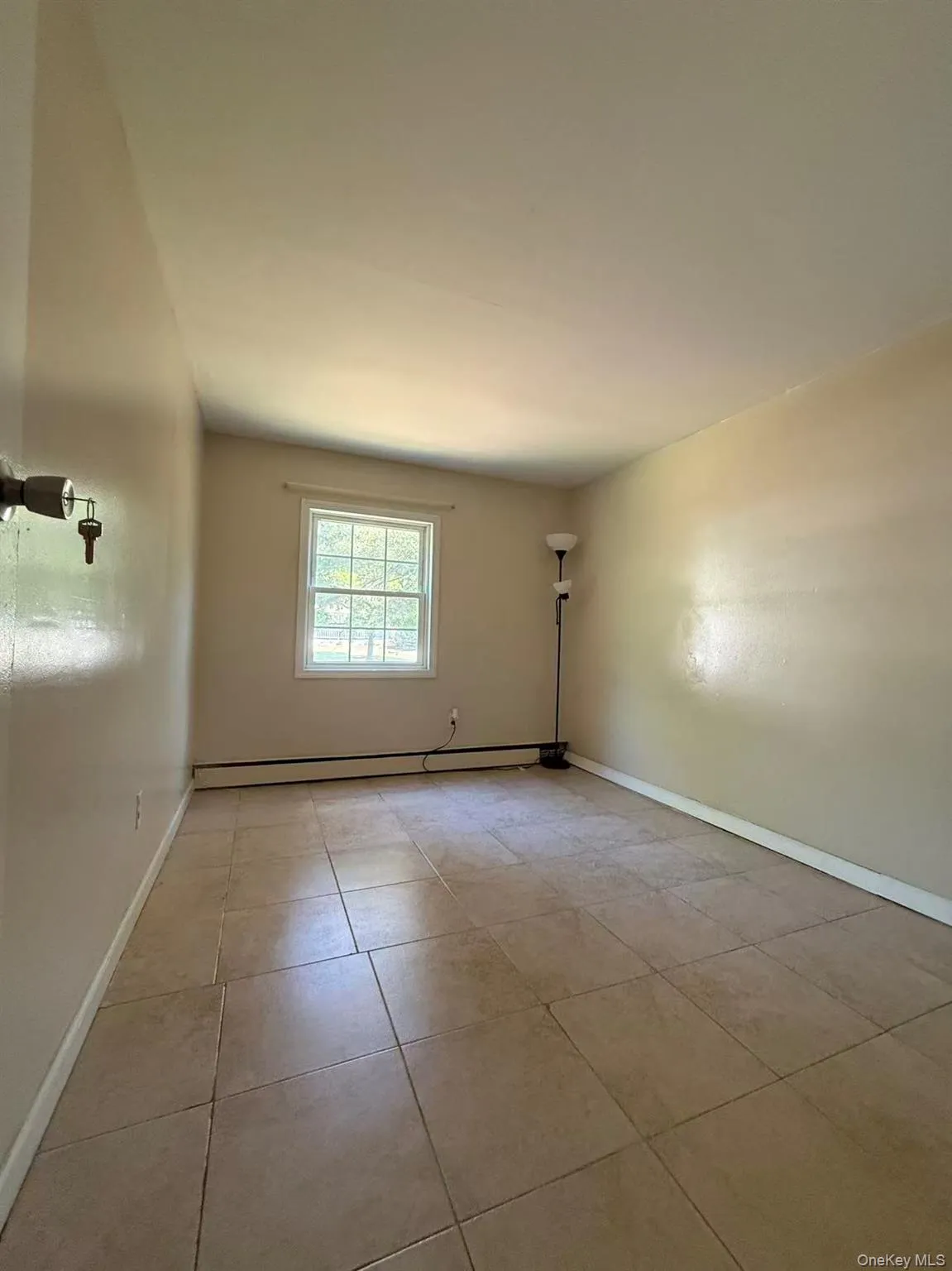 Neutral-toned walls complement the tiled flooring Neutral-toned walls complement the tiled flooring