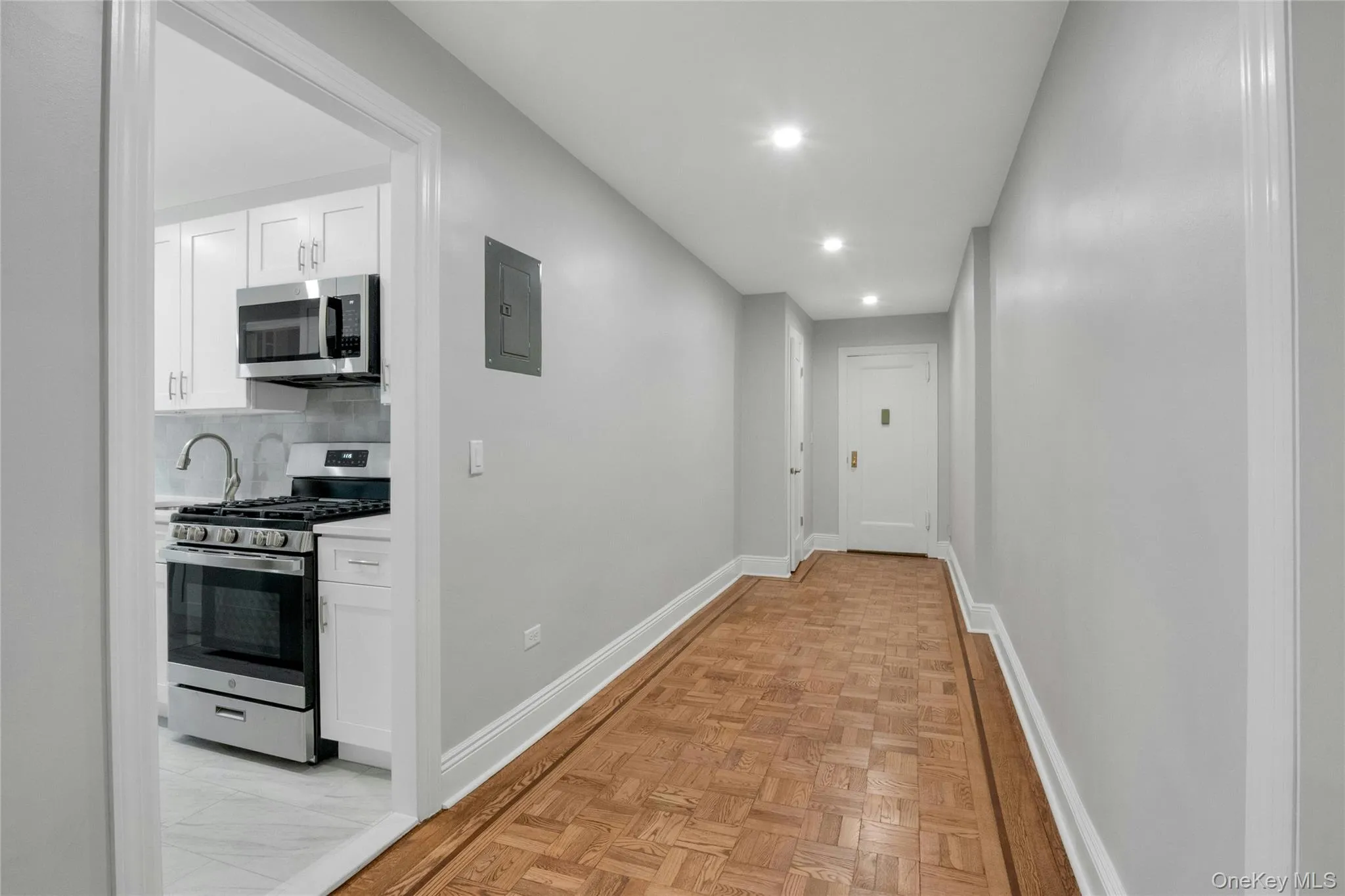 Looking at long foyer to the front door into the kitchen Looking at long foyer to the front door into the kitchen