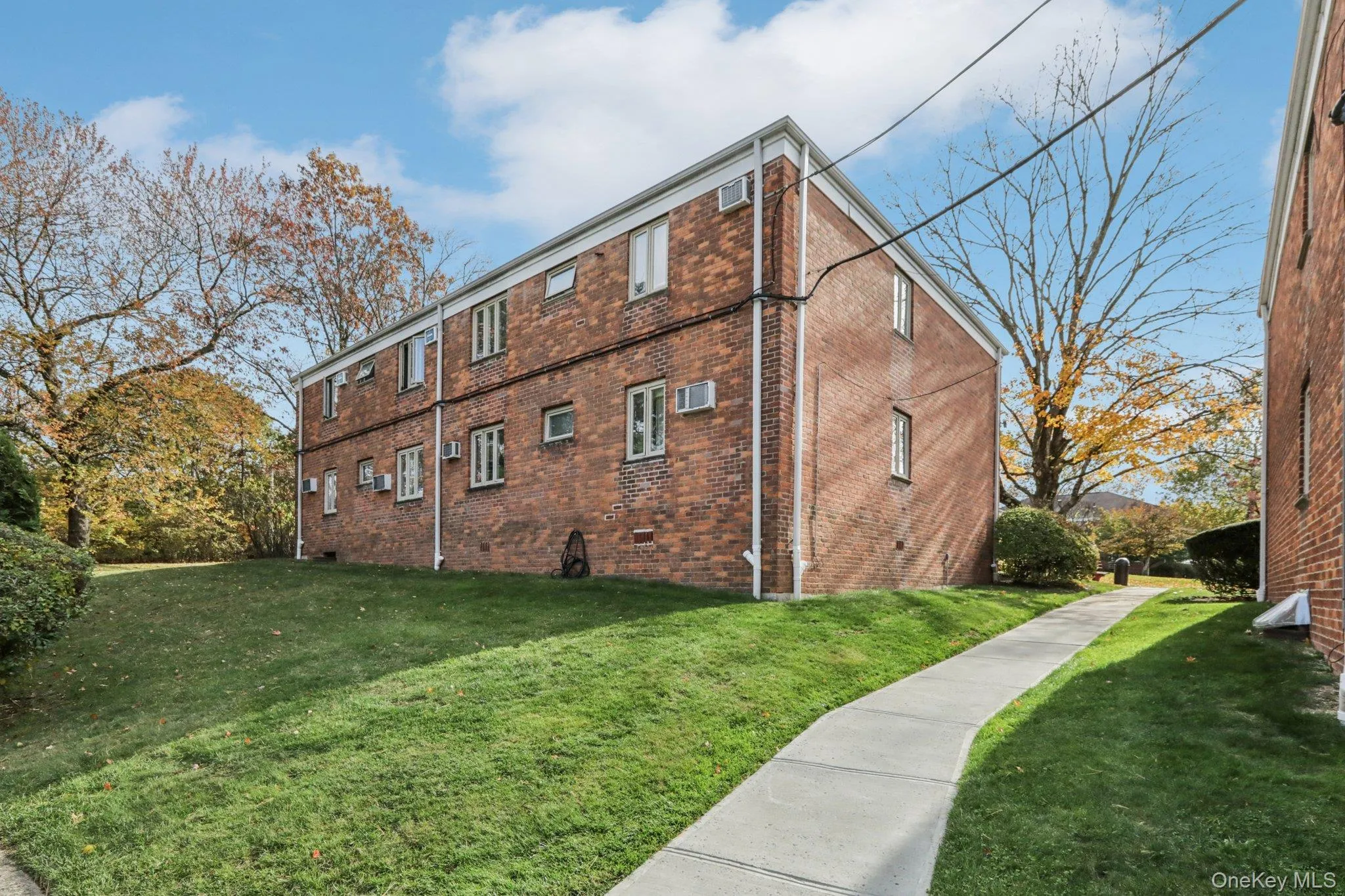 View of side of home with a yard, brick siding, and crawl space View of side of home with a yard, brick siding, and crawl space