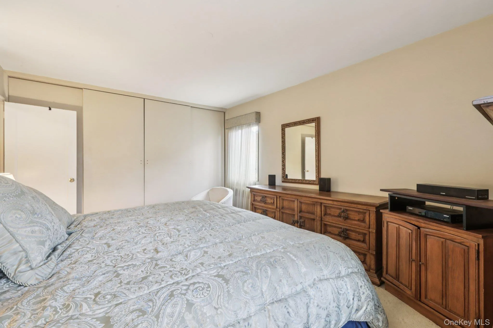Bedroom featuring a closet and light colored carpet Bedroom featuring a closet and light colored carpet