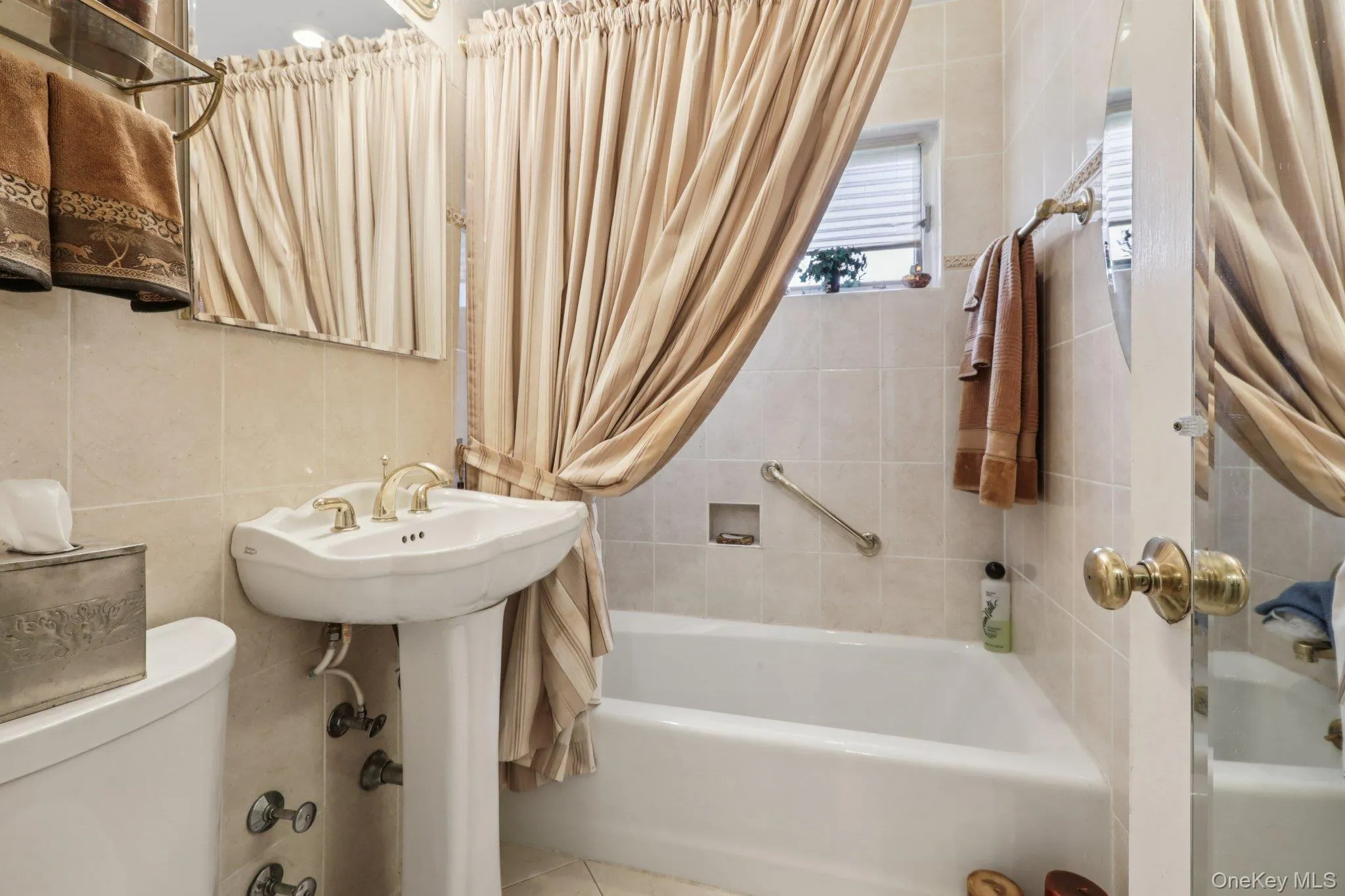 Bathroom with shower / bath combo with shower curtain and tile walls Bathroom with shower / bath combo with shower curtain and tile walls