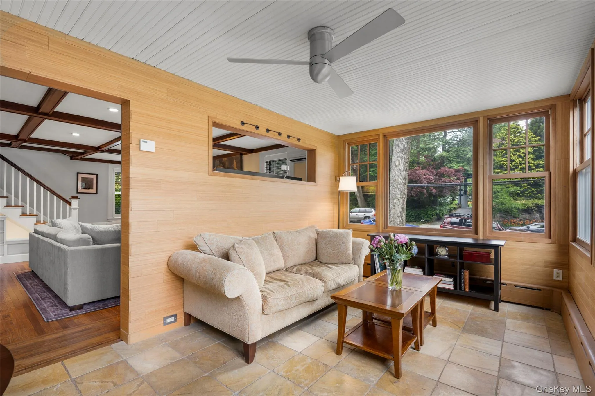 A sun-filled family room with a wall of windows. A sun-filled family room with a wall of windows.