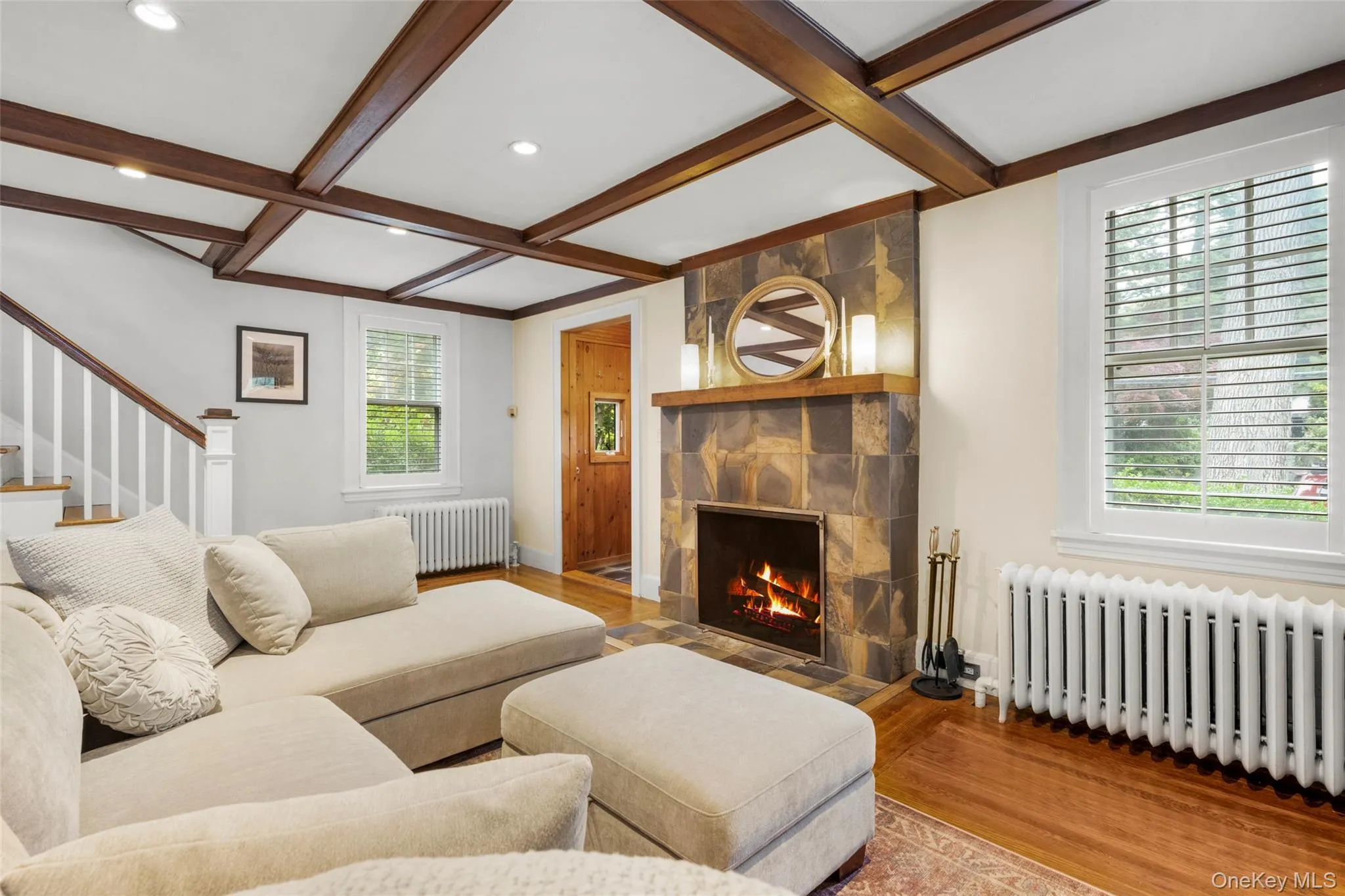 Formal living room with a wood-burning fireplace, built-in bookcase, and closet. Formal living room with a wood-burning fireplace, built-in bookcase, and closet.