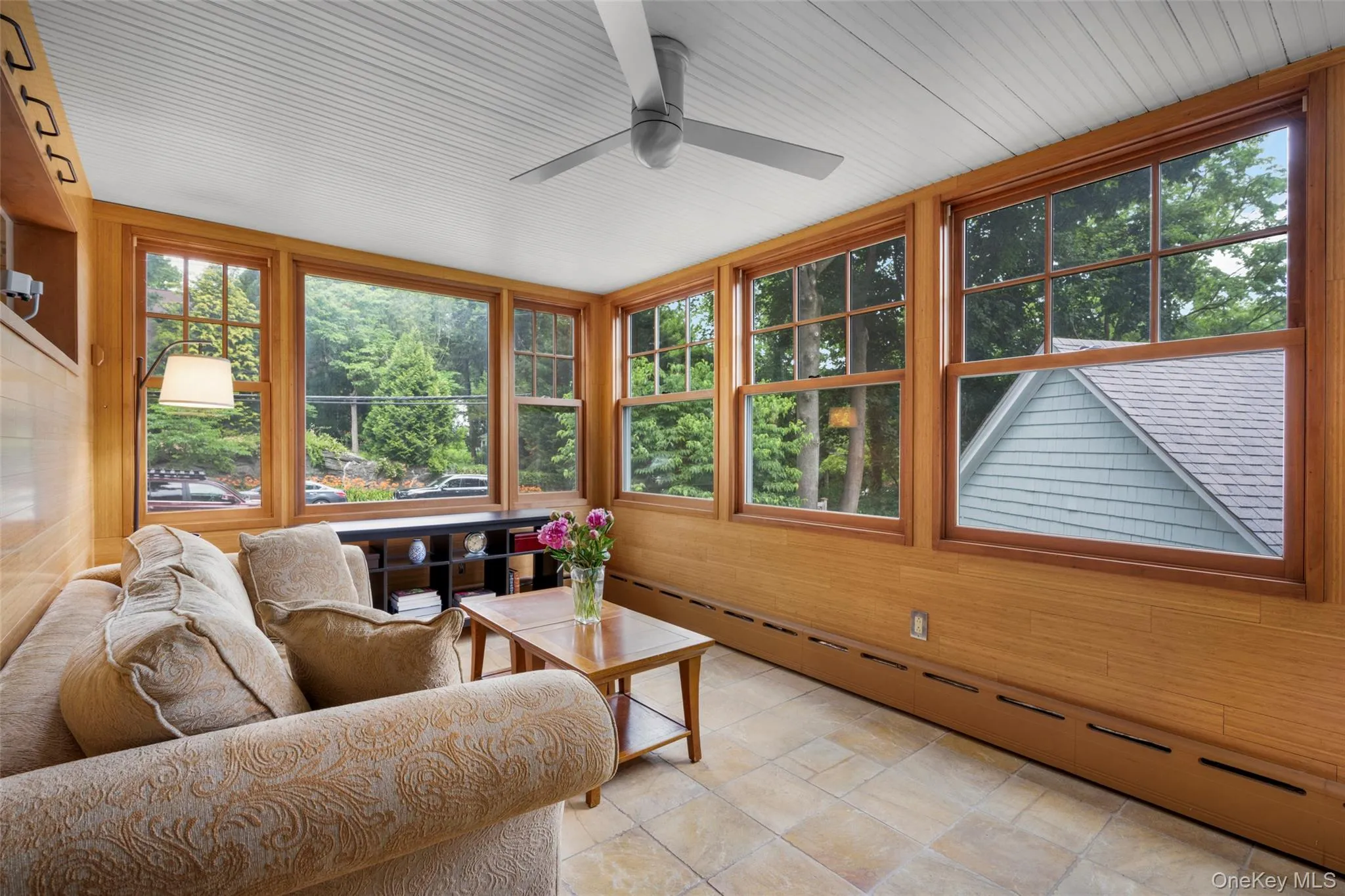 A sun-filled family room with a wall of windows. A sun-filled family room with a wall of windows.