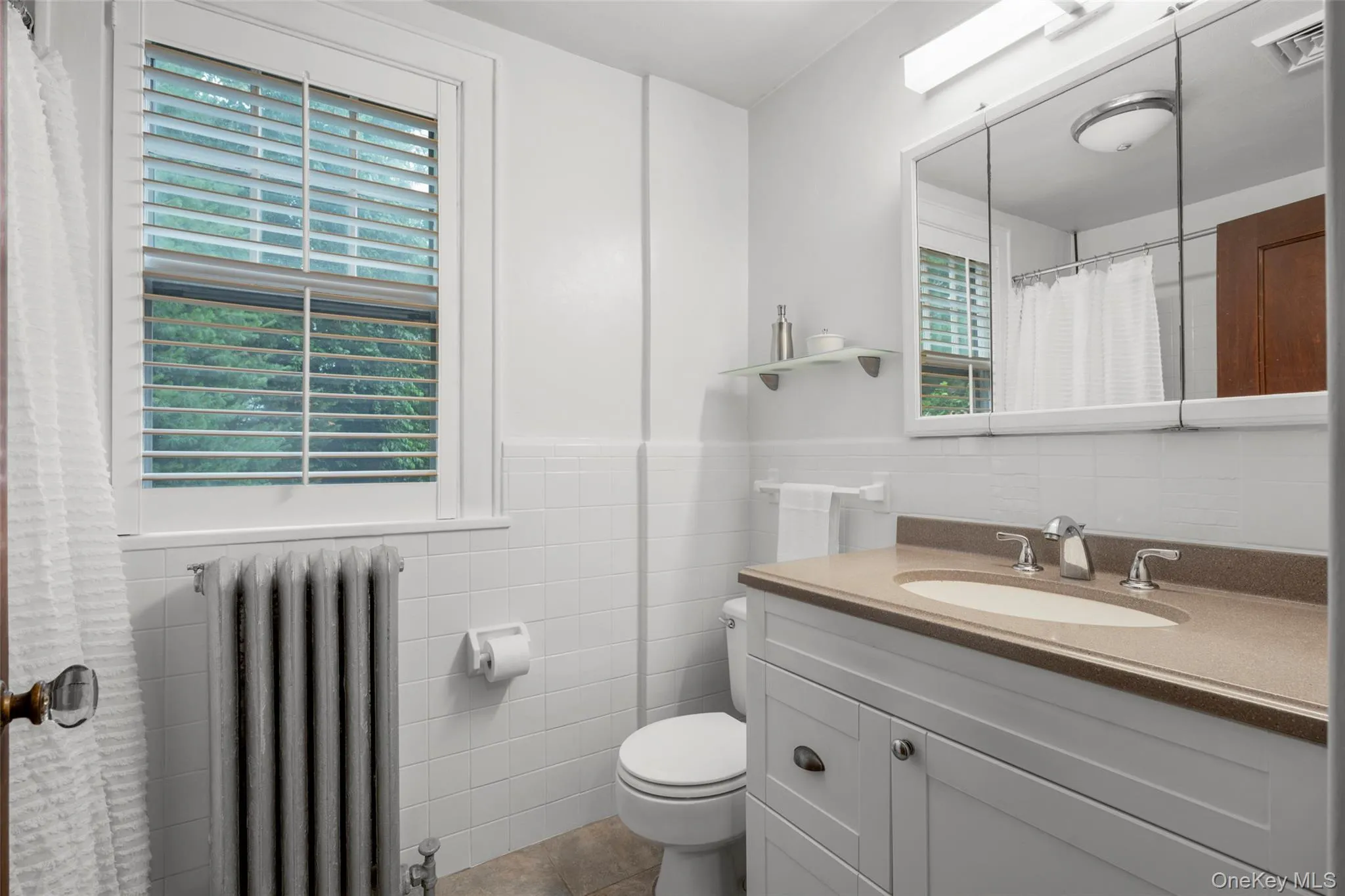Full hallway bathroom with a tub. Full hallway bathroom with a tub.
