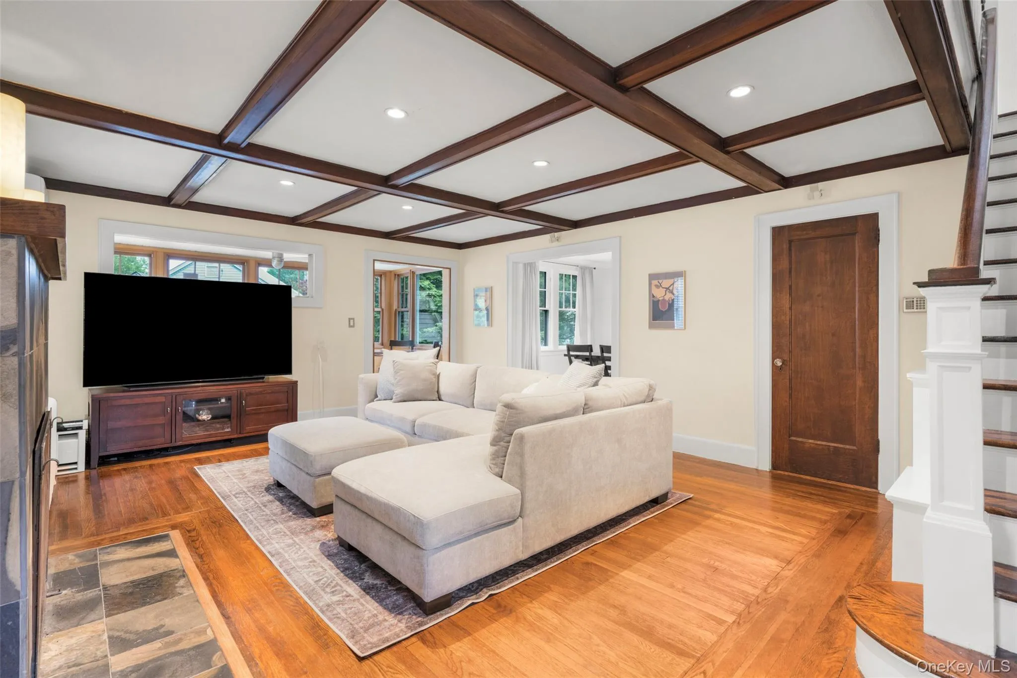 Formal living room with a wood-burning fireplace, built-in bookcase, and closet. Formal living room with a wood-burning fireplace, built-in bookcase, and closet.