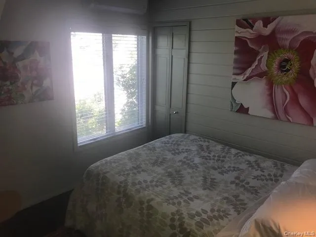 Bedroom featuring wood walls Bedroom featuring wood walls