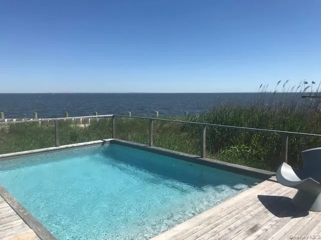 Outdoor pool with a water view Outdoor pool with a water view