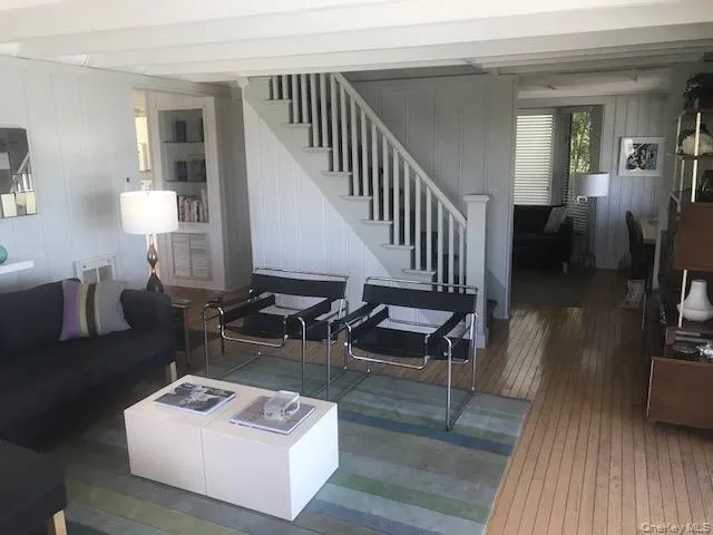 Living room with hardwood / wood-style floors and stairs Living room with hardwood / wood-style floors and stairs