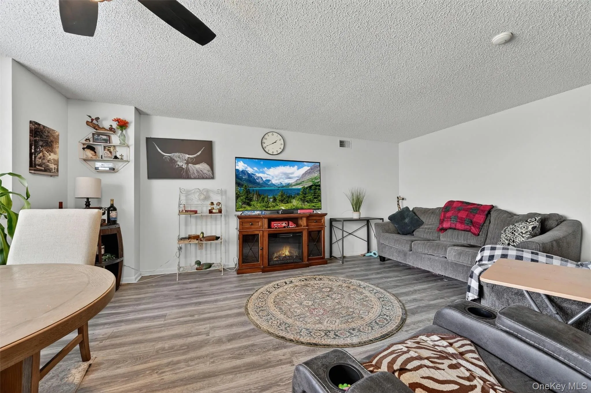 The living room. The entire home is accented with laminate flooring. The living room. The entire home is accented with laminate flooring.