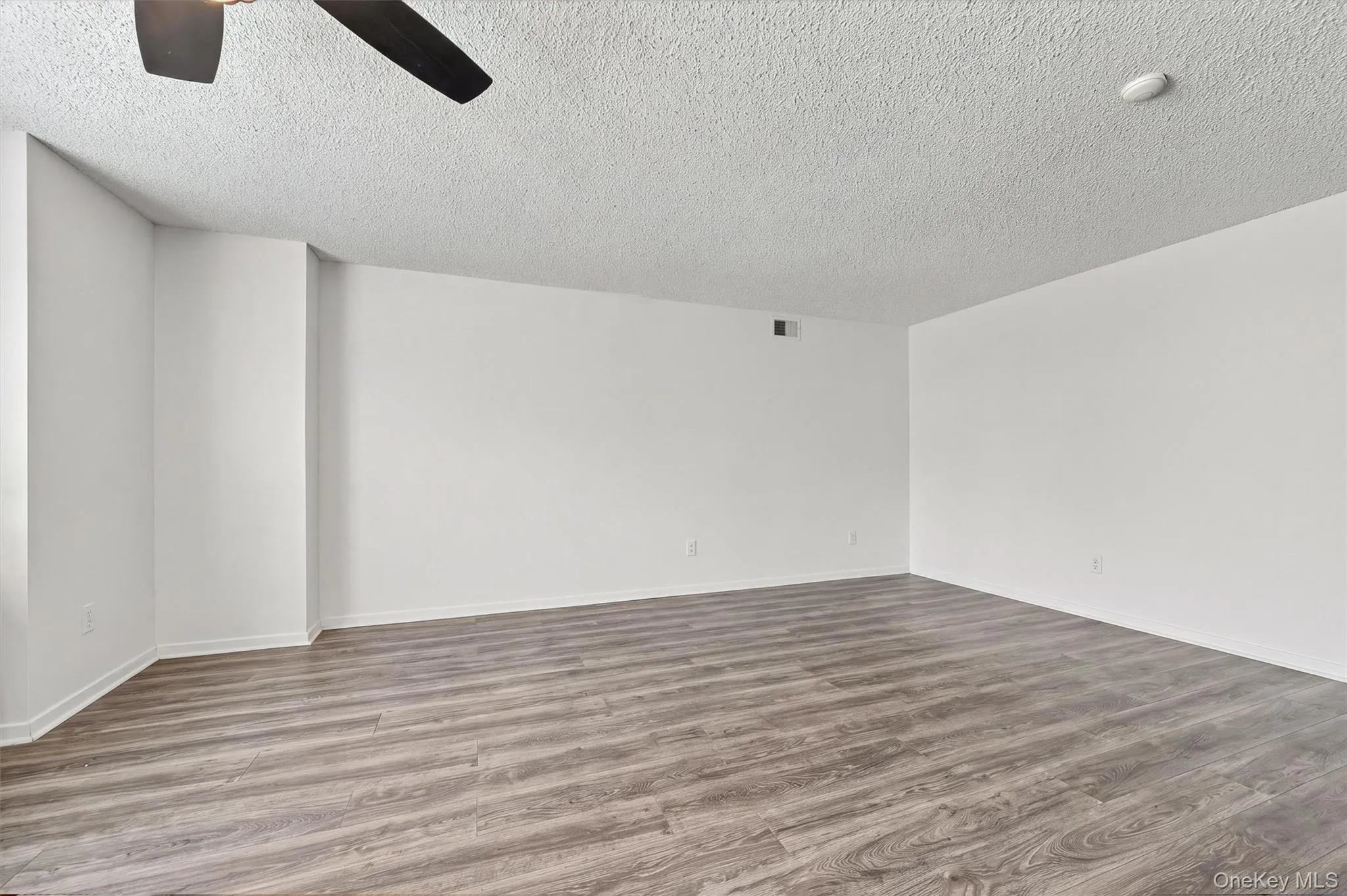 The living room. The entire home is accented with laminate flooring. The living room. The entire home is accented with laminate flooring.