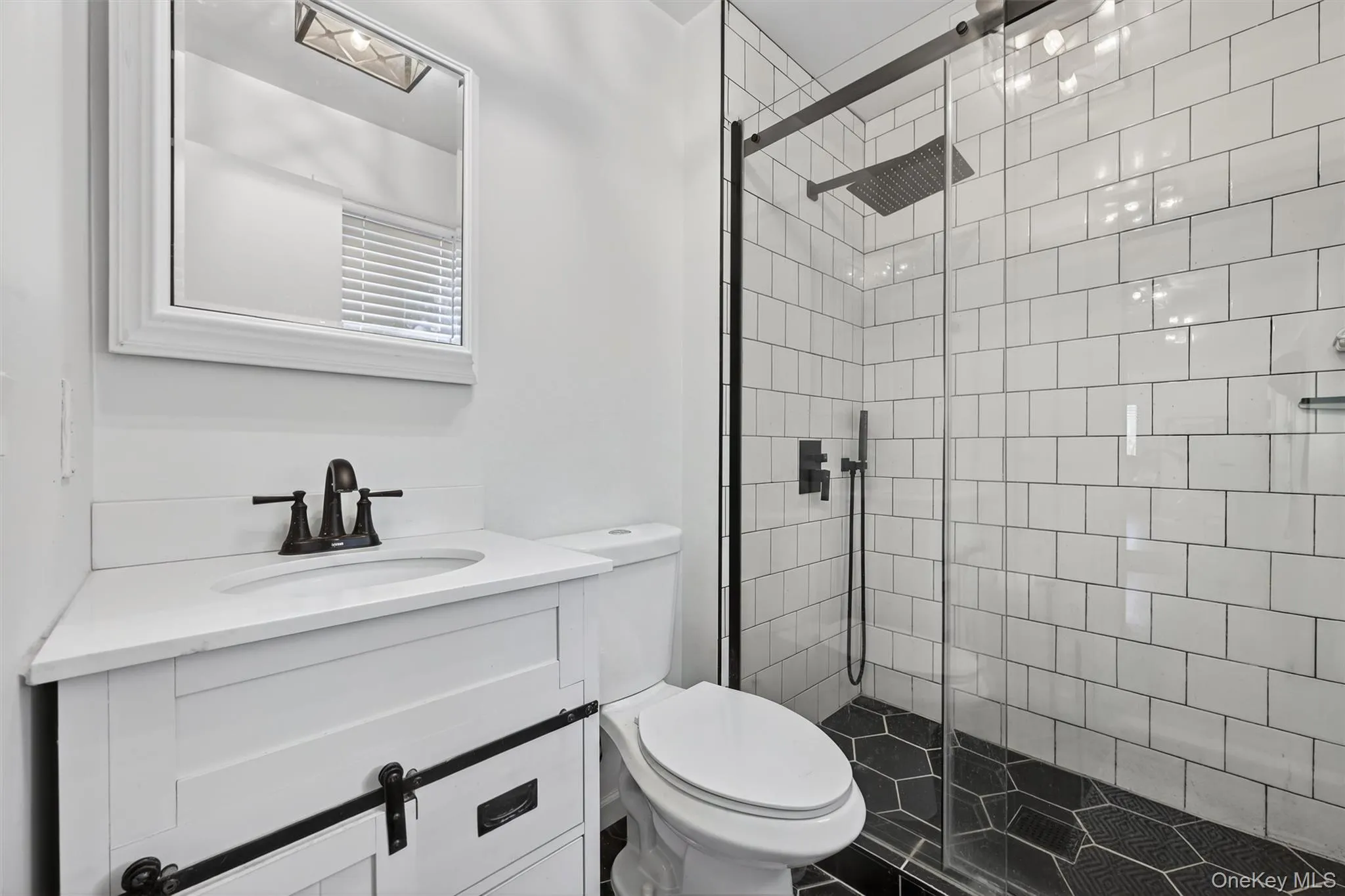Updated bathroom with custom tile and glass doors. Updated bathroom with custom tile and glass doors.
